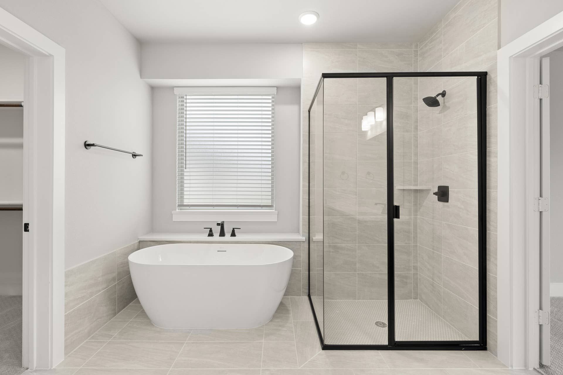 Modern bathroom with freestanding tub and glass-enclosed shower.