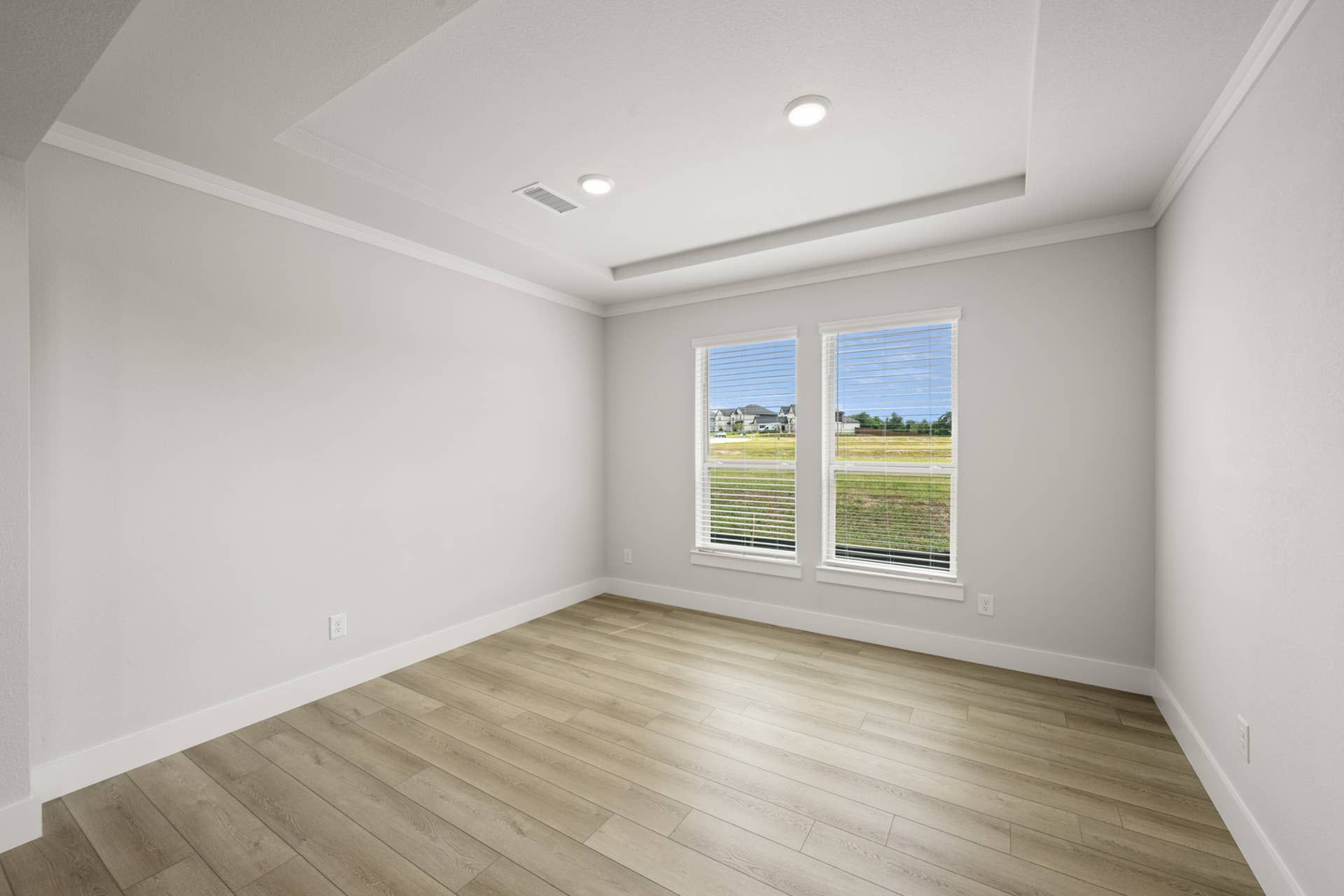 Bright flex space with wood flooring and large windows overlooking scenic view.