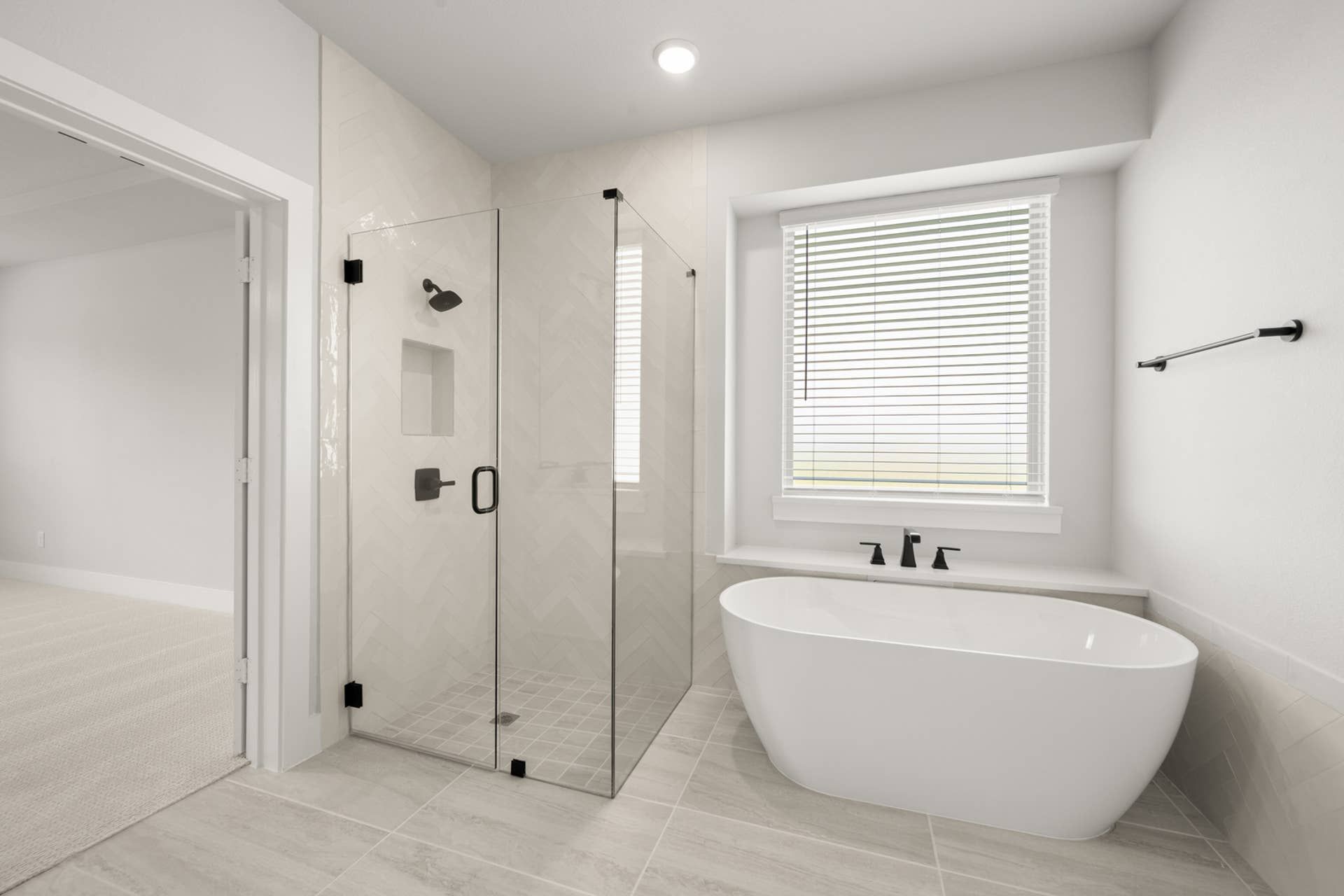 Modern bathroom with glass shower, freestanding tub, and large window with blinds.