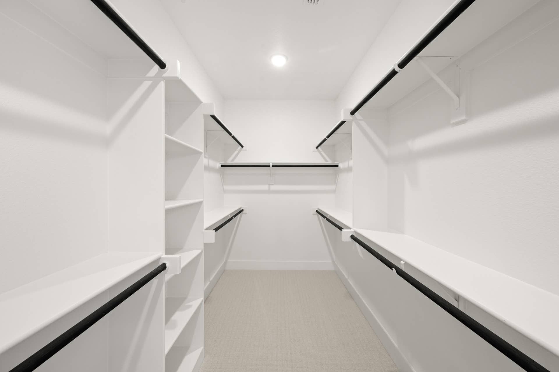 Spacious walk-in closet with ample shelving and hanging space.