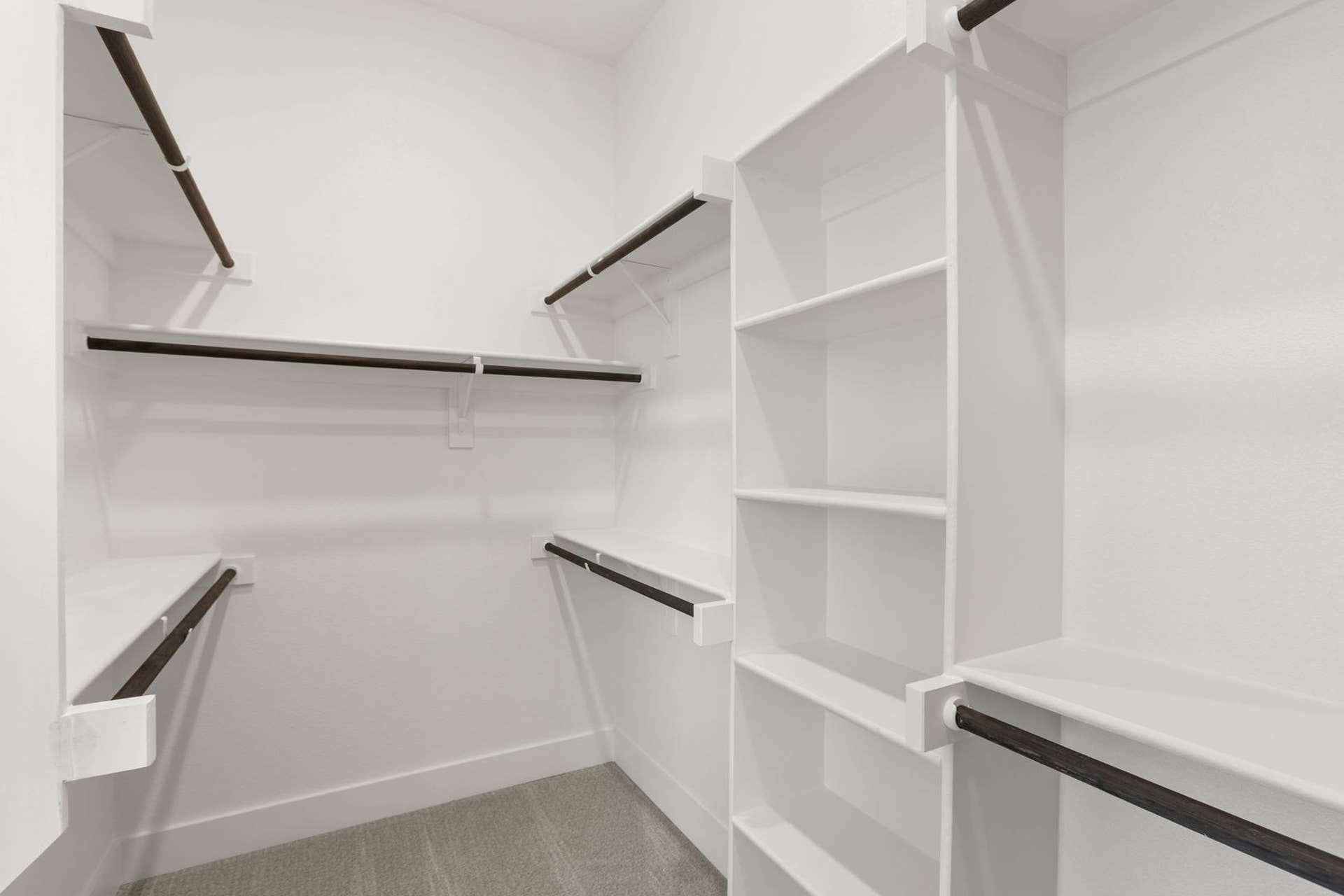 Spacious walk-in closet with multiple shelves and hanging rods.
