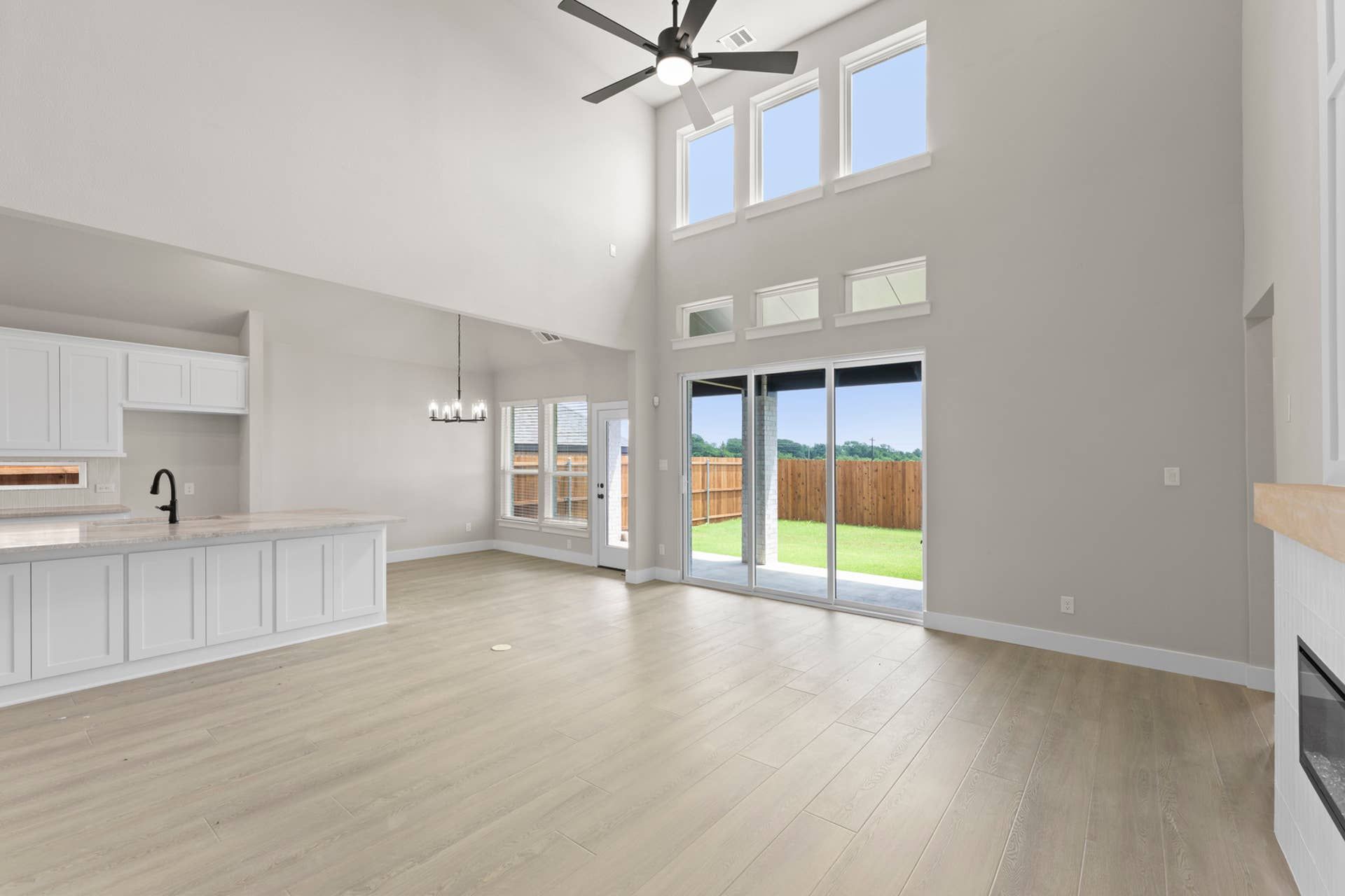 Spacious open-concept living area with high ceilings and large windows.