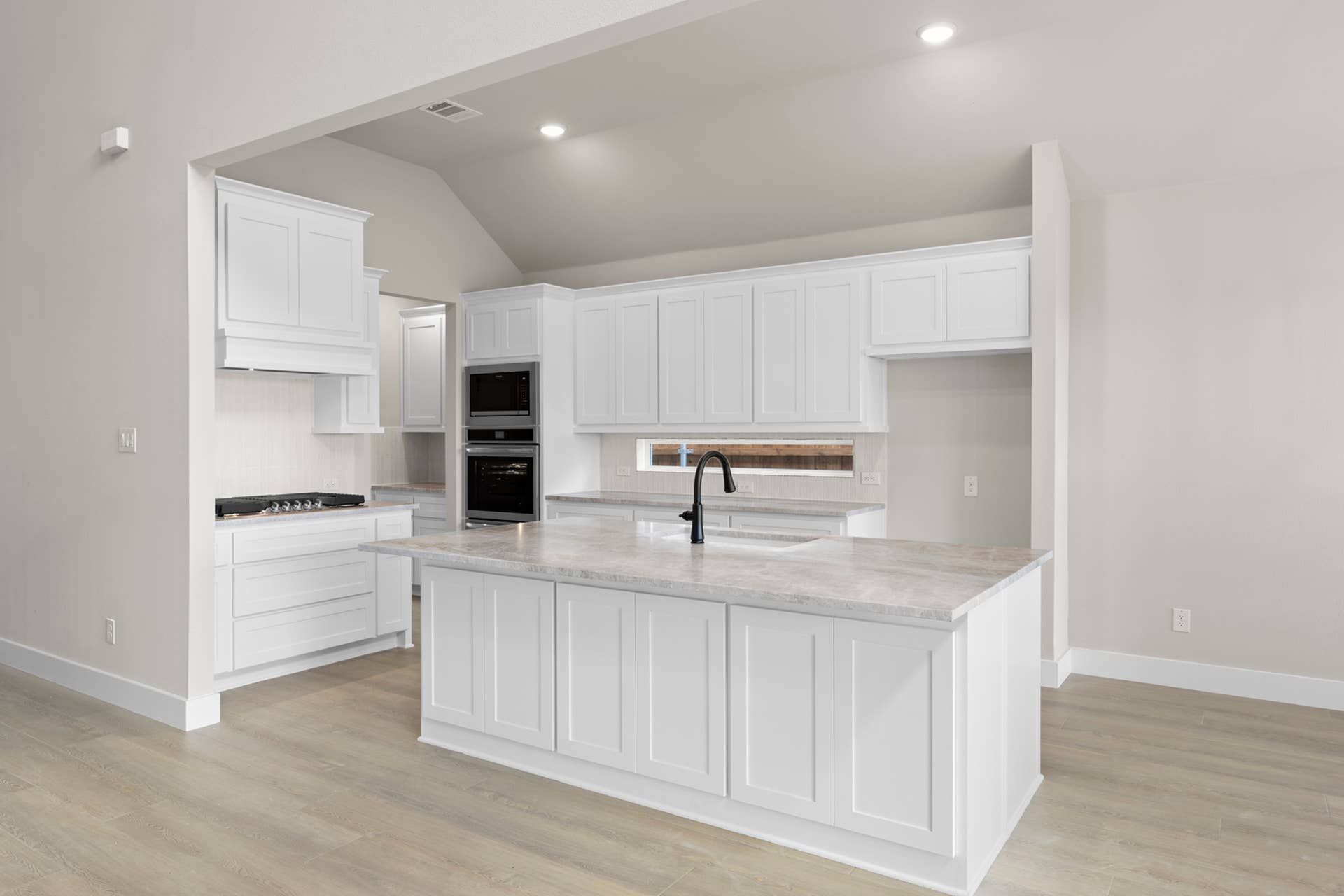 Modern kitchen with white cabinetry and sleek countertops.