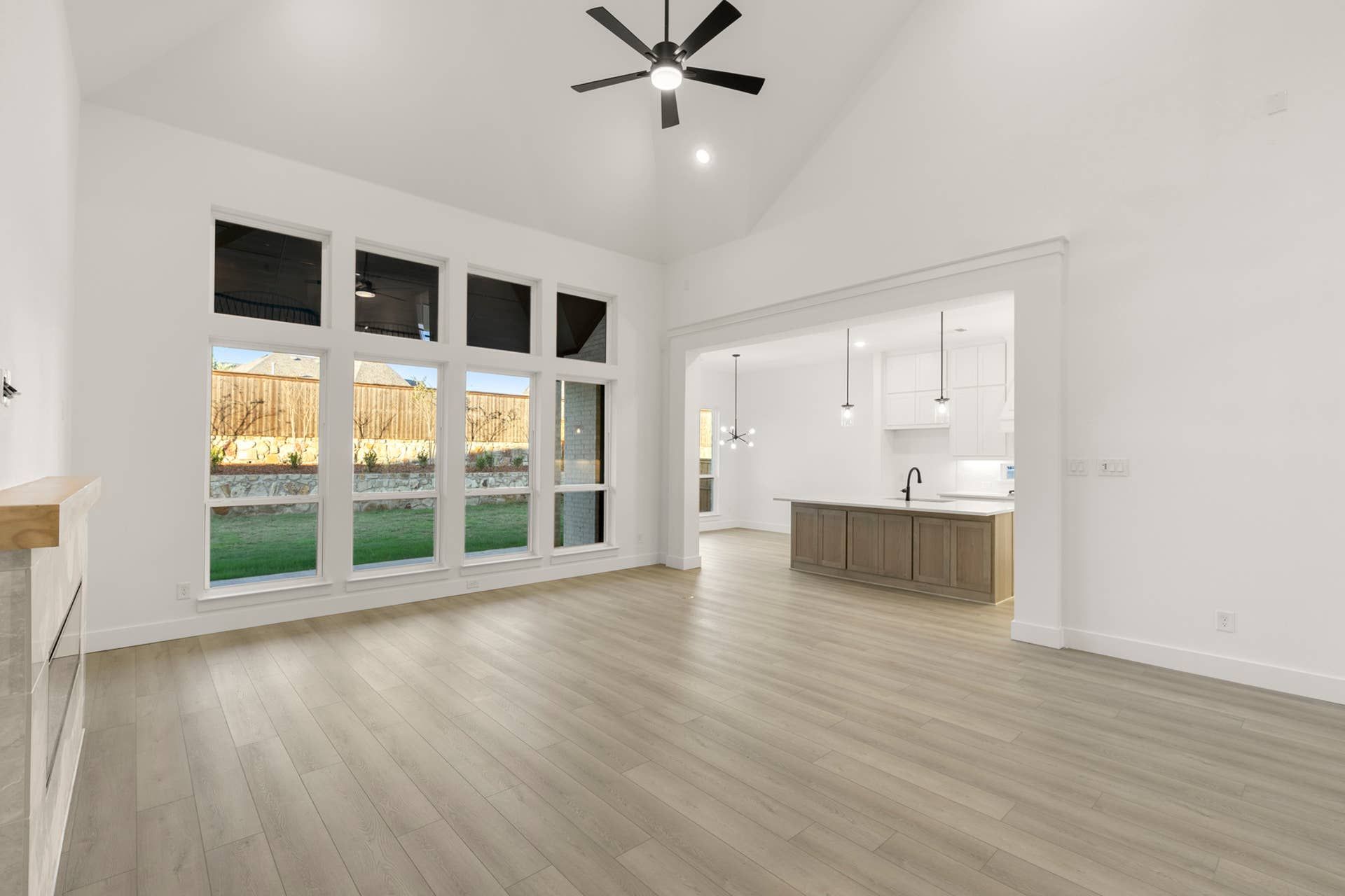 Spacious open-concept living area with large windows and modern kitchen island.