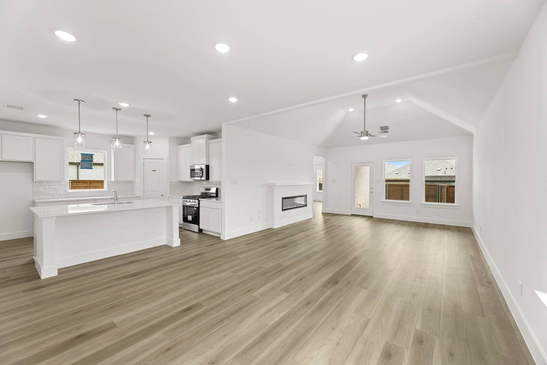 Spacious open-concept kitchen and dining area with modern finishes and wood flooring.