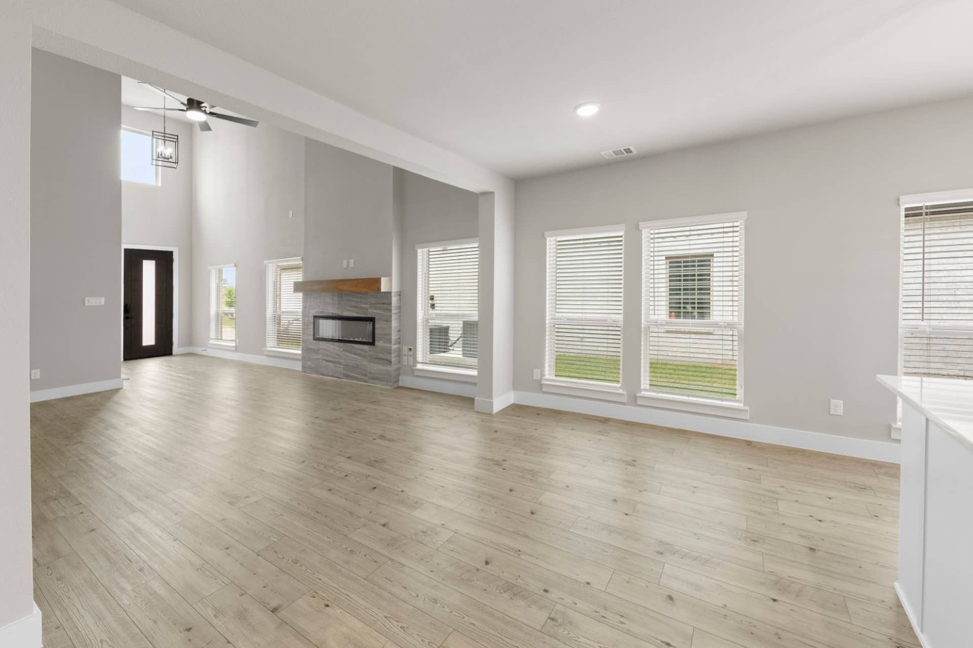 Spacious dining area with modern fireplace and large windows.