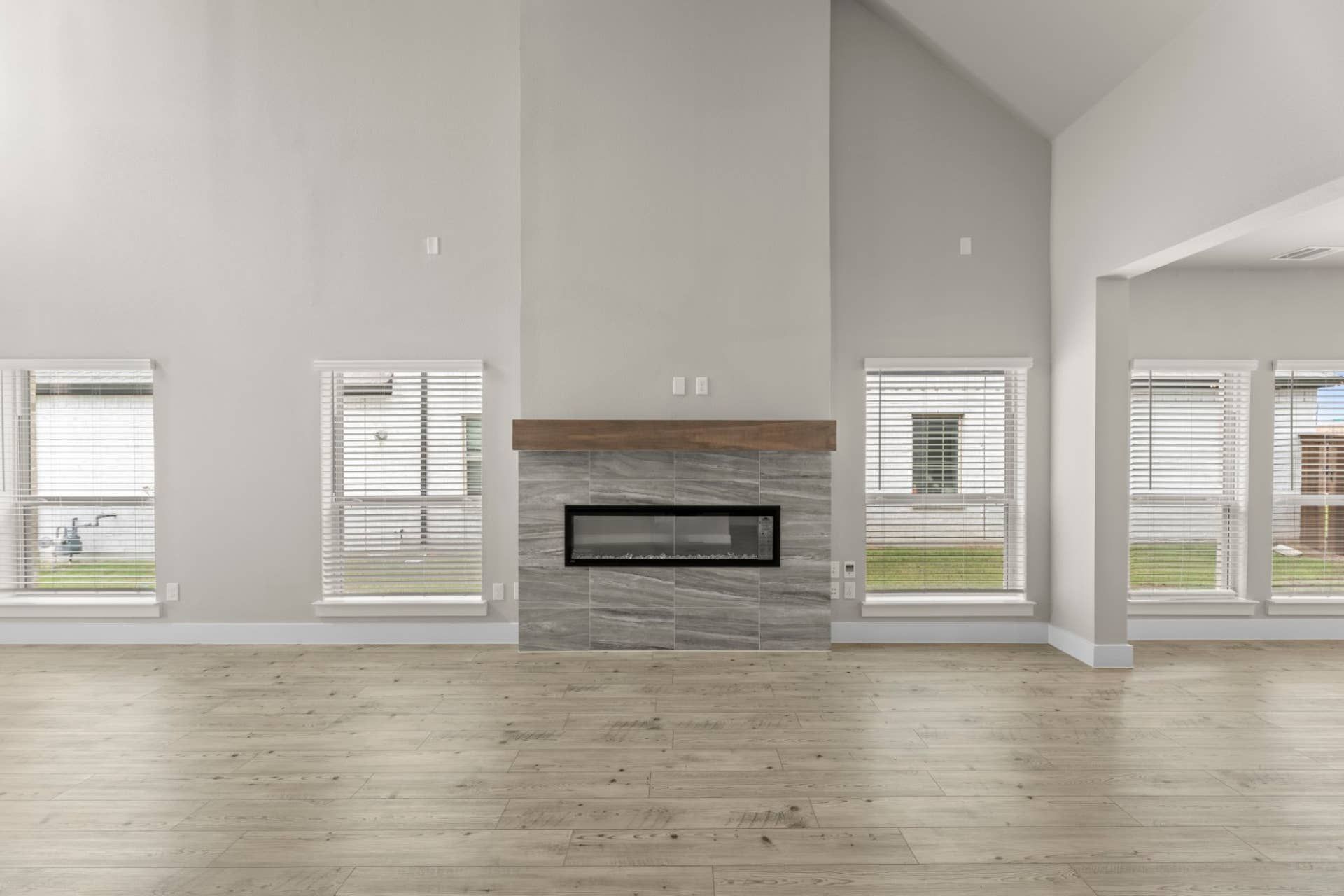 Spacious living room with modern fireplace and large windows.