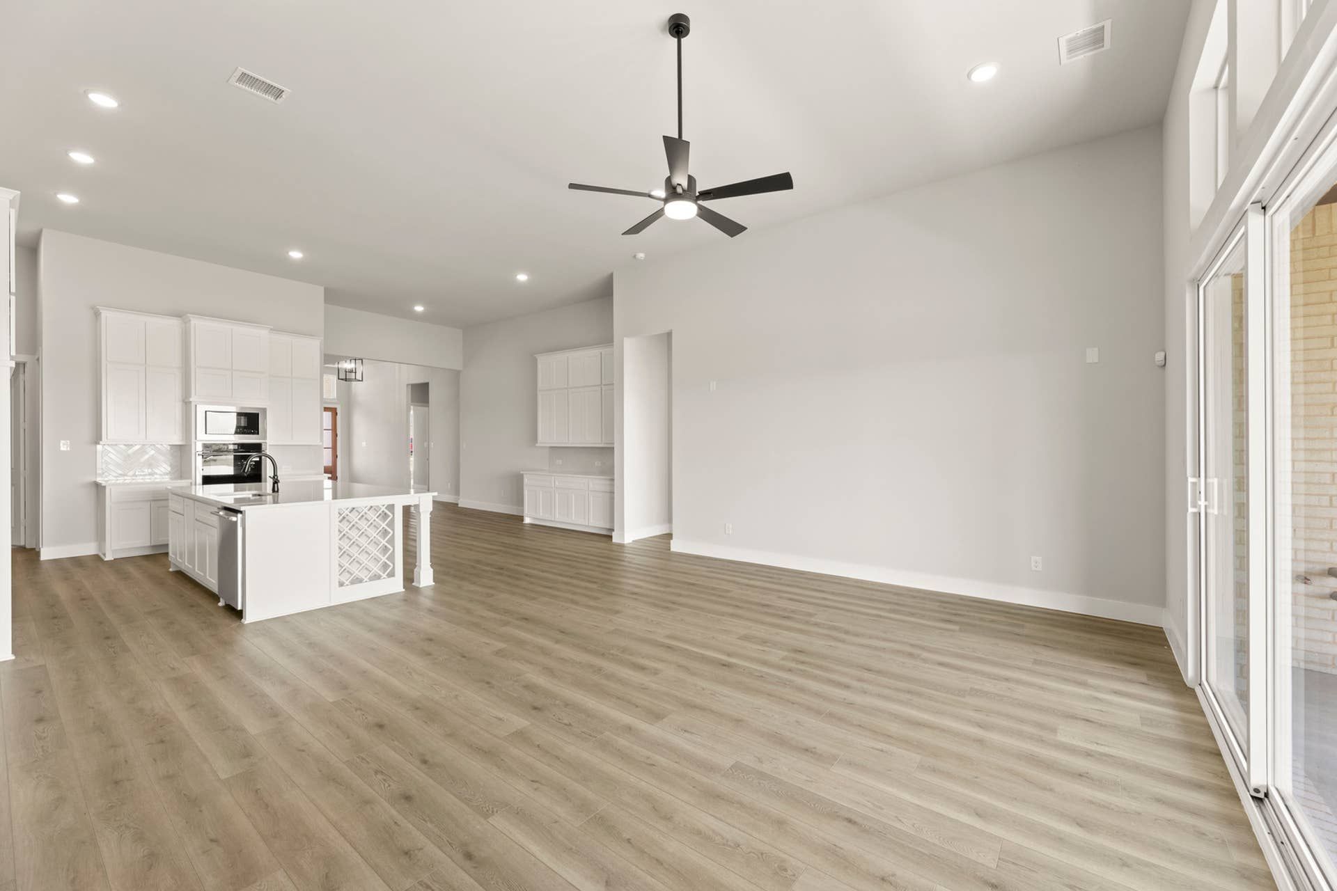 Open-concept kitchen and living area with modern finishes and hardwood flooring.