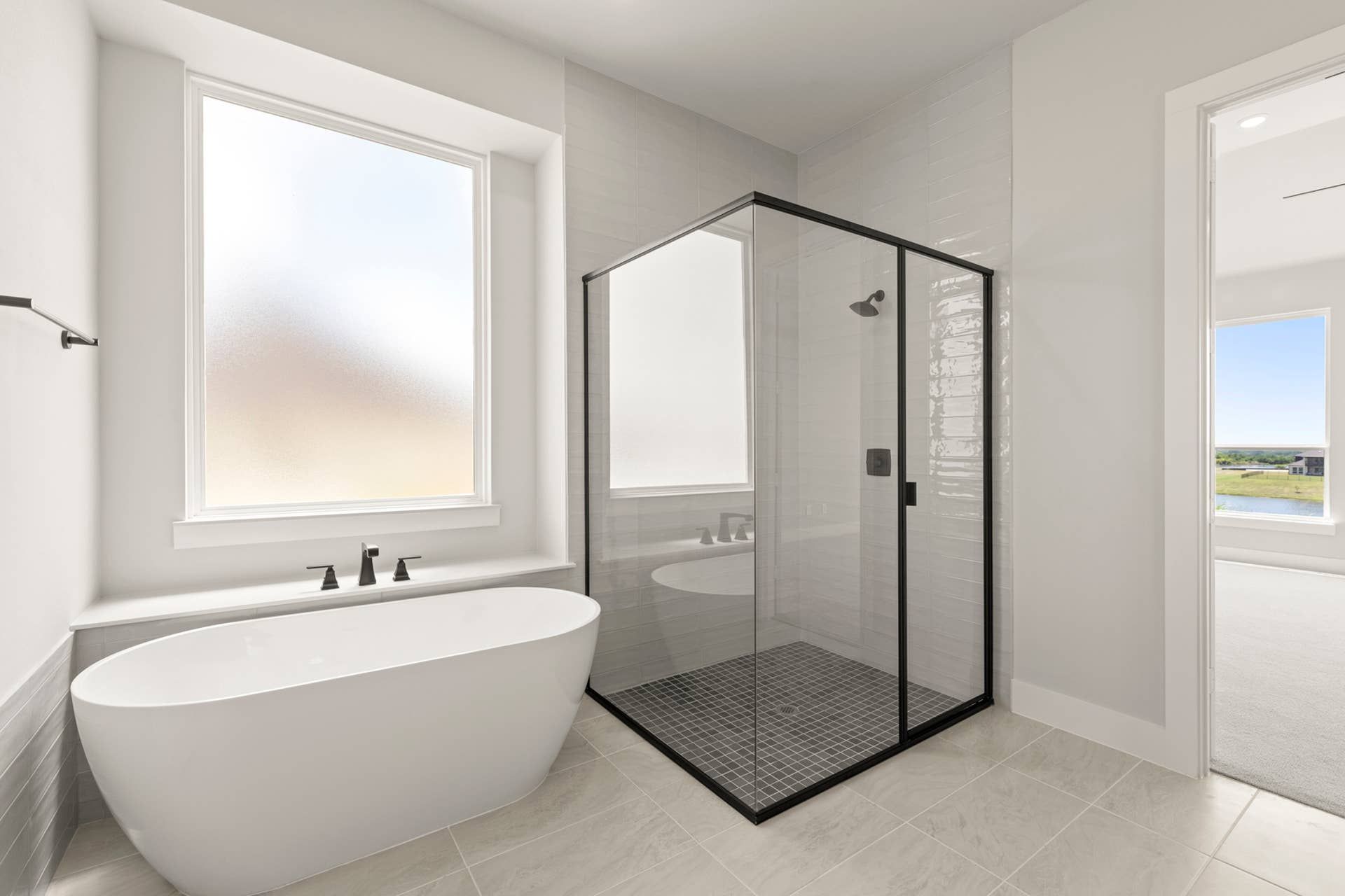 Modern bathroom with freestanding tub and glass-enclosed shower.