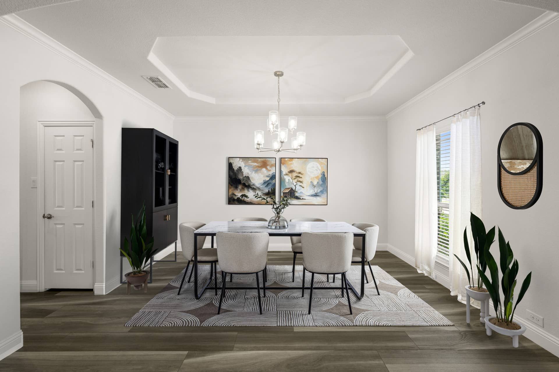 Elegant dining room with modern chandelier and contemporary art pieces on white walls.