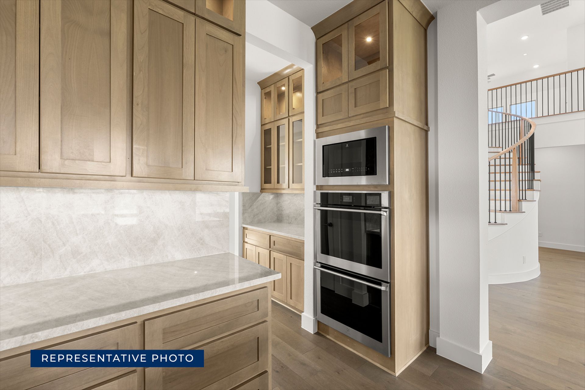 Modern kitchen with wooden cabinets and built-in stainless steel appliances.