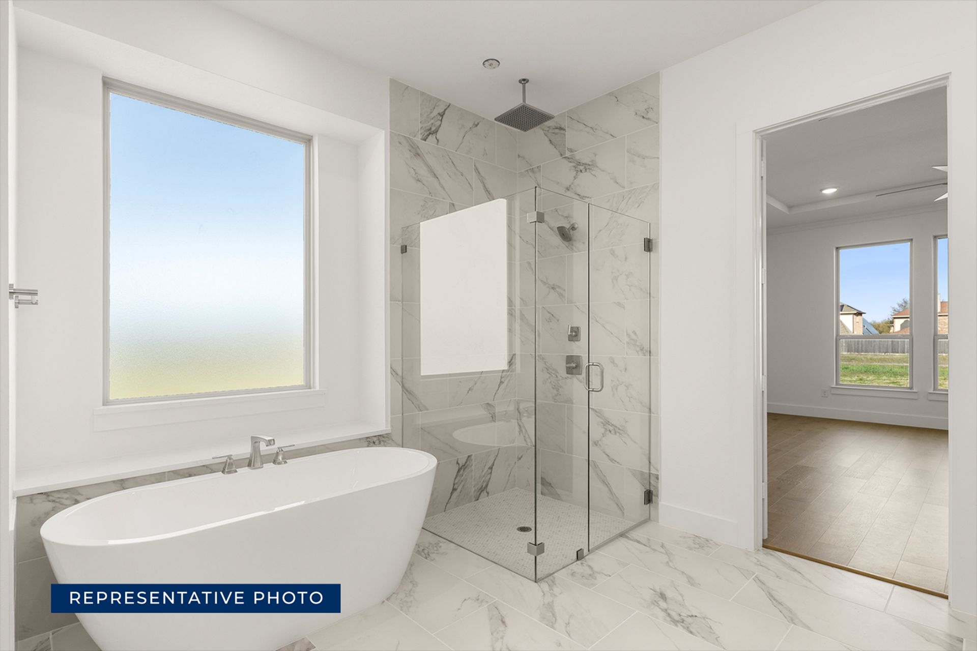 Modern bathroom with freestanding tub and glass shower enclosure.