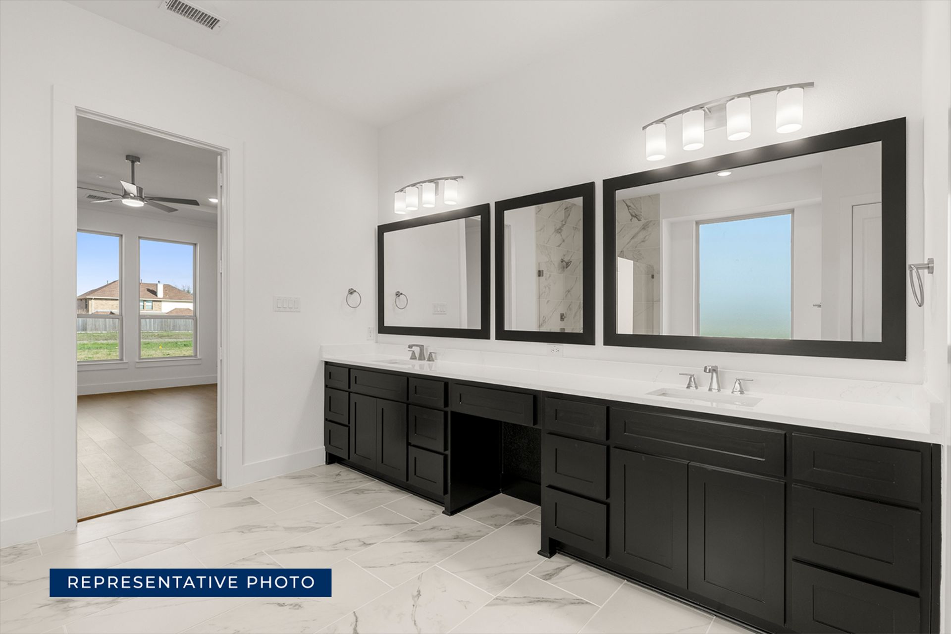 Modern bathroom with dual sinks, large mirrors, and marble flooring.
