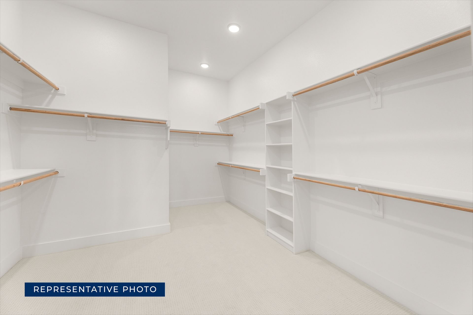 Spacious walk-in closet with ample shelving and hanging space.