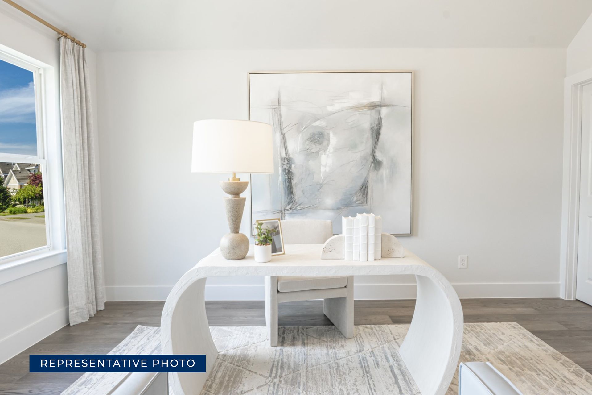 Modern home office with abstract art and minimalist decor.