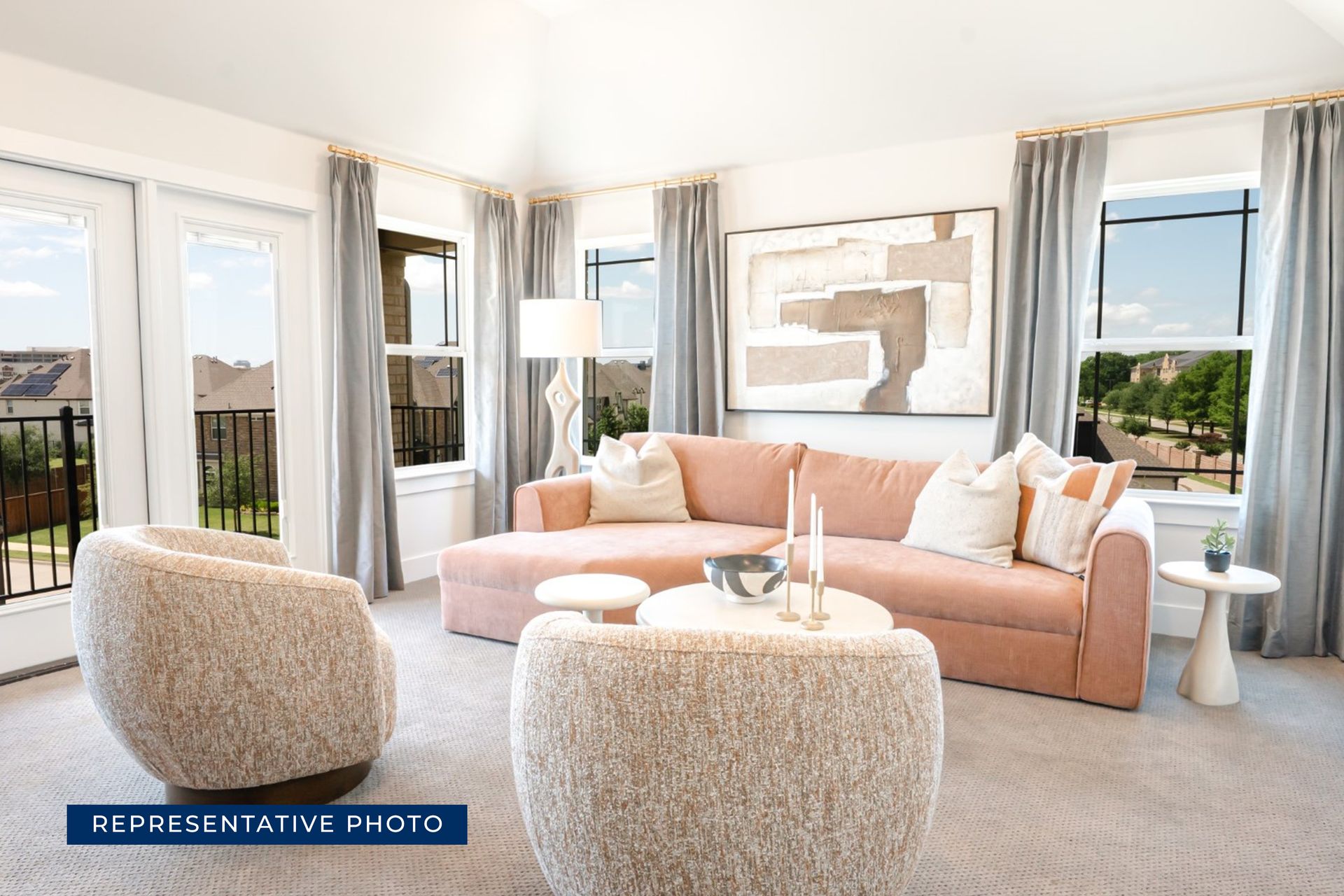 Modern living room with beige furniture and large windows.