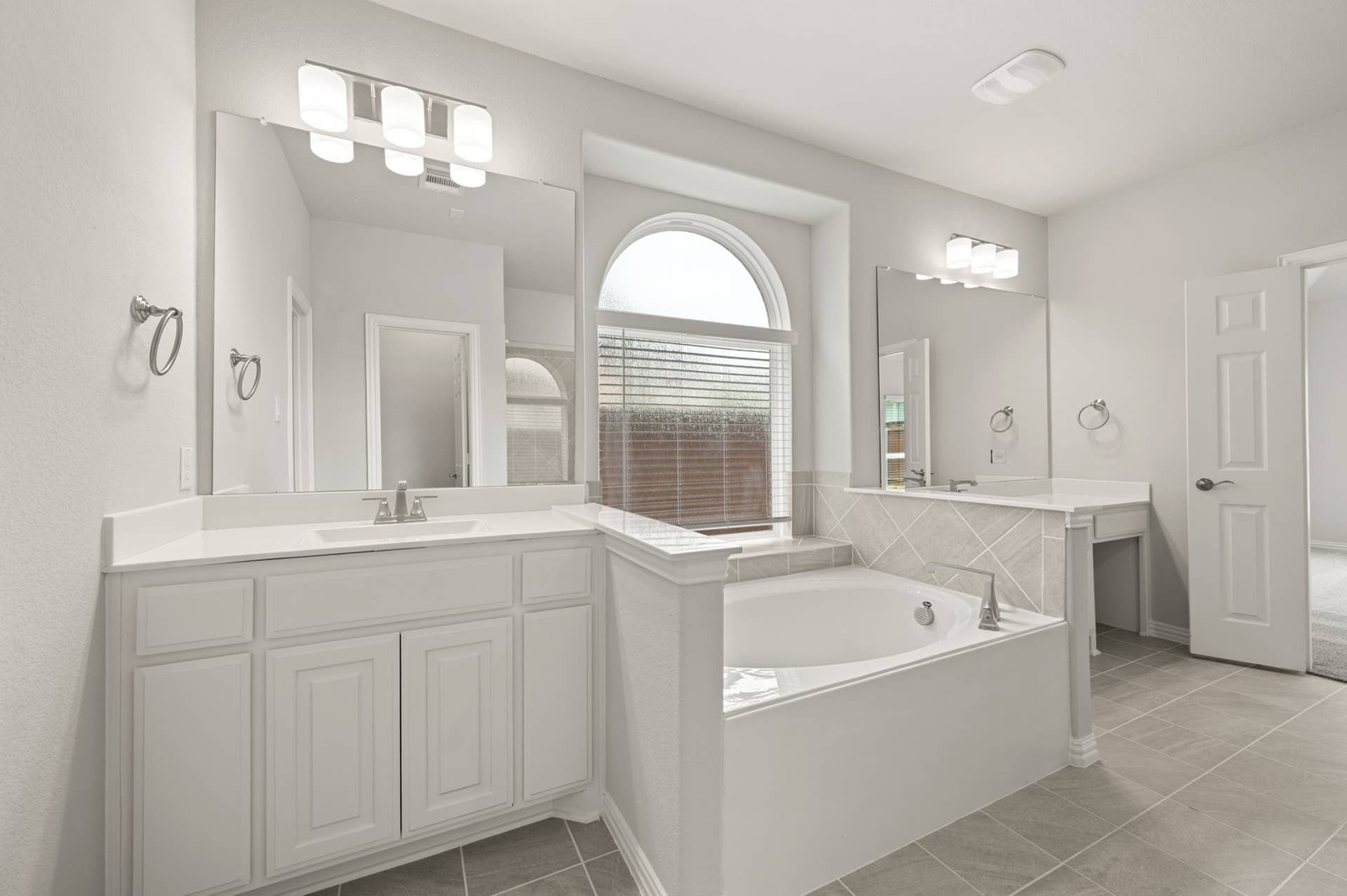 Elegant primary suite bathroom with dual vanities and soaking tub.
