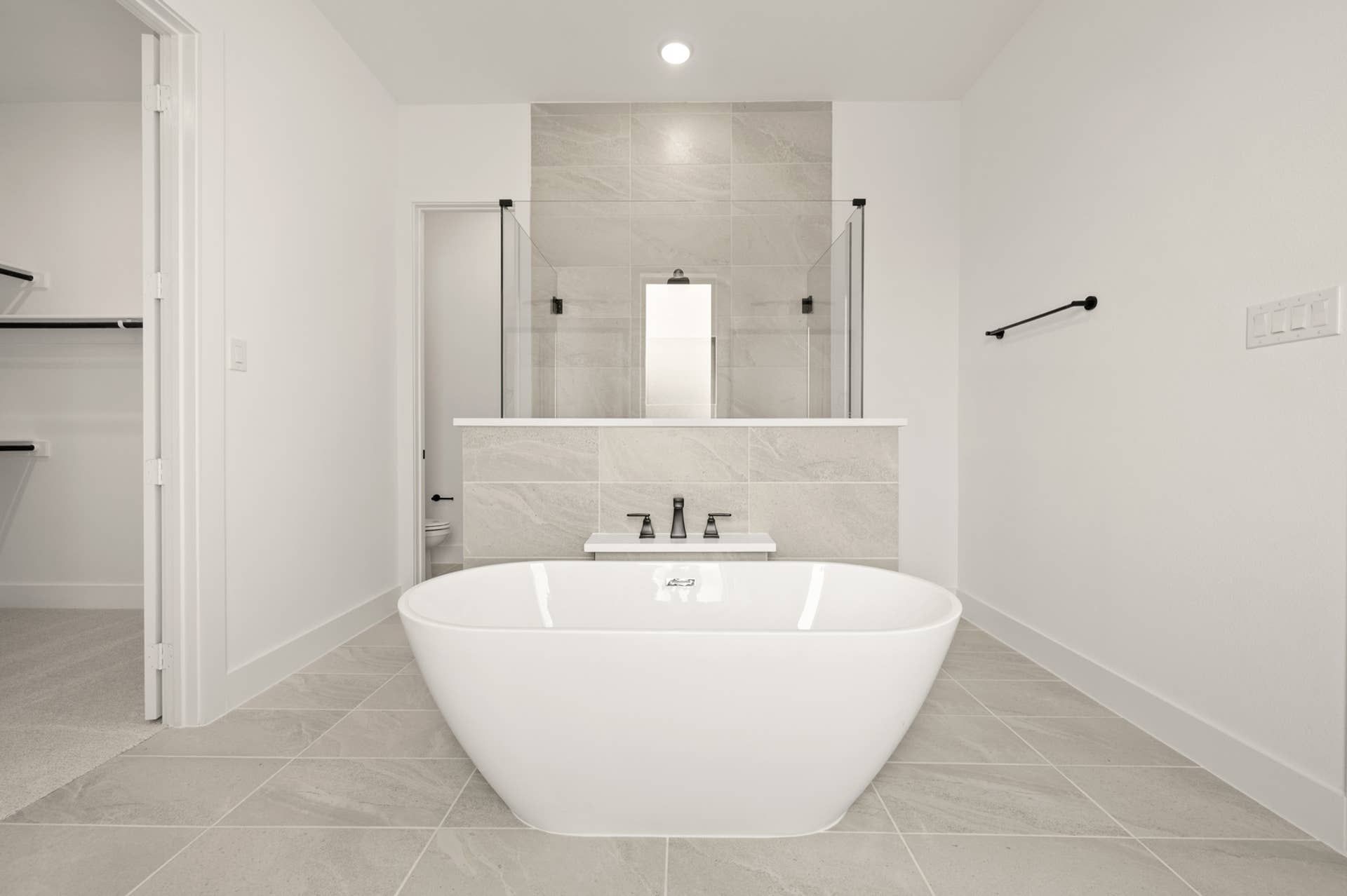 Modern bathroom with freestanding tub and elegant tile accents.