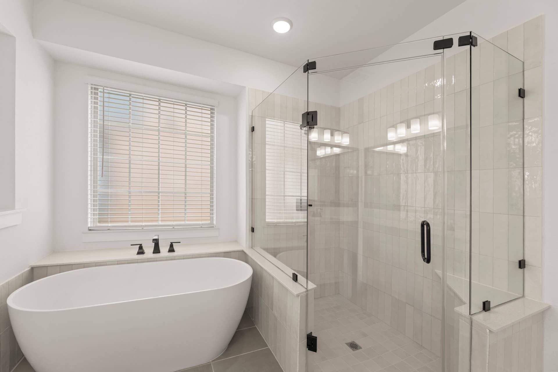 Modern bathroom featuring a freestanding tub and glass-enclosed shower.