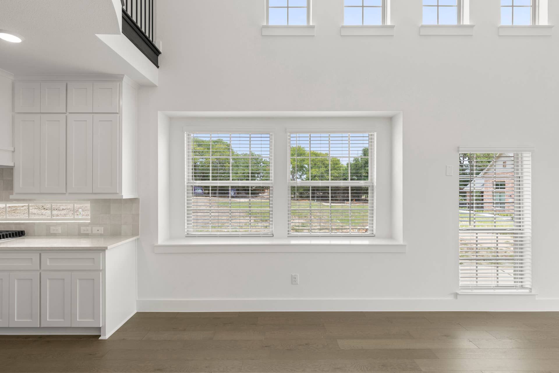 Bright dining area with large windows and hardwood floors.