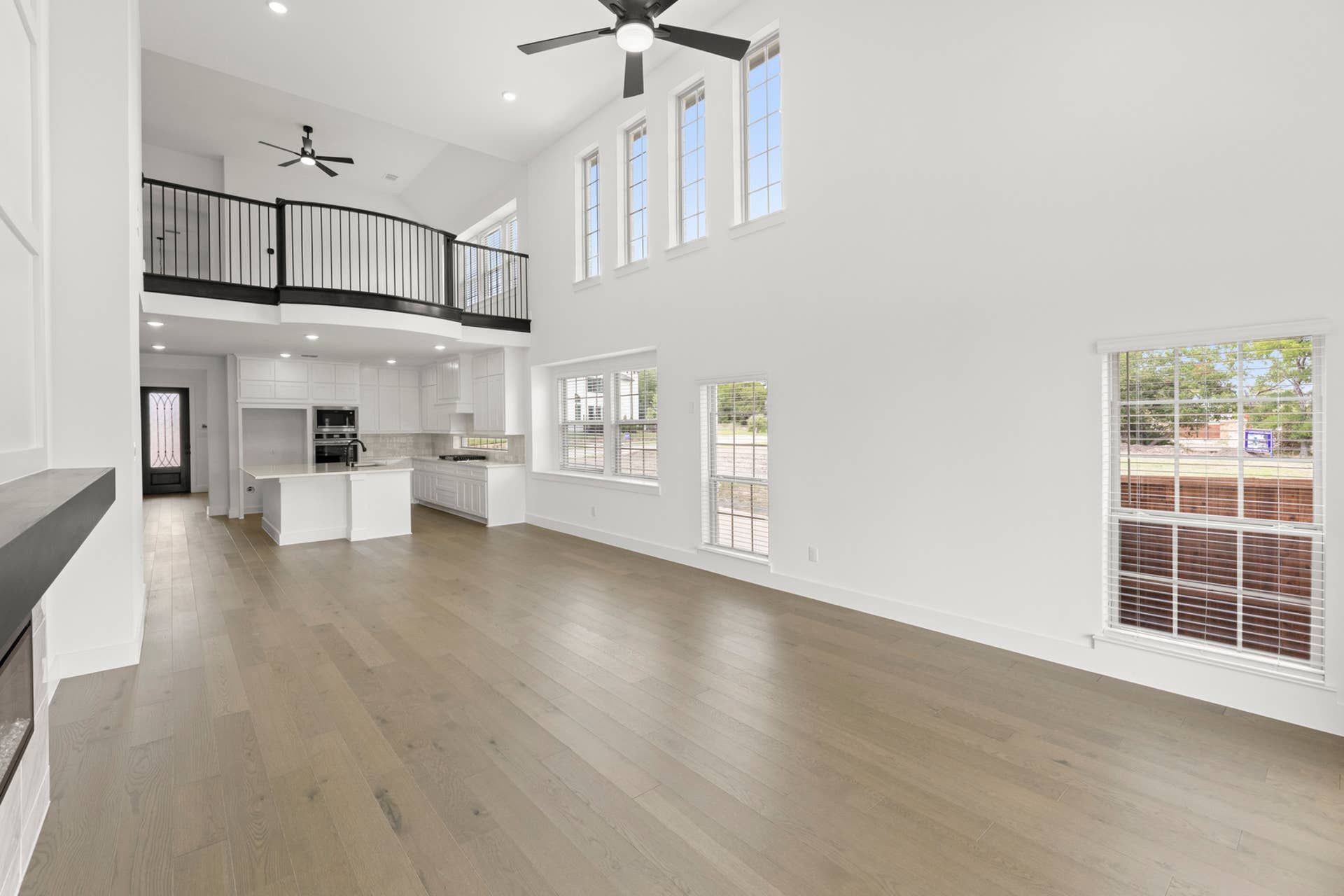 Spacious open-concept living area with high ceilings and modern kitchen.