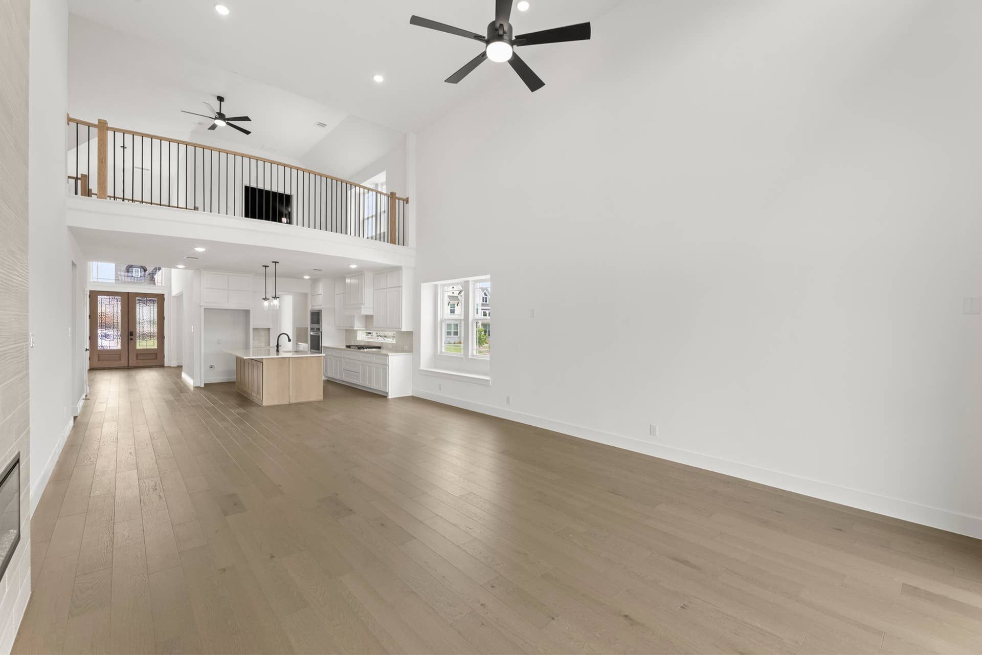 Spacious open-concept living area with vaulted ceiling and modern kitchen.