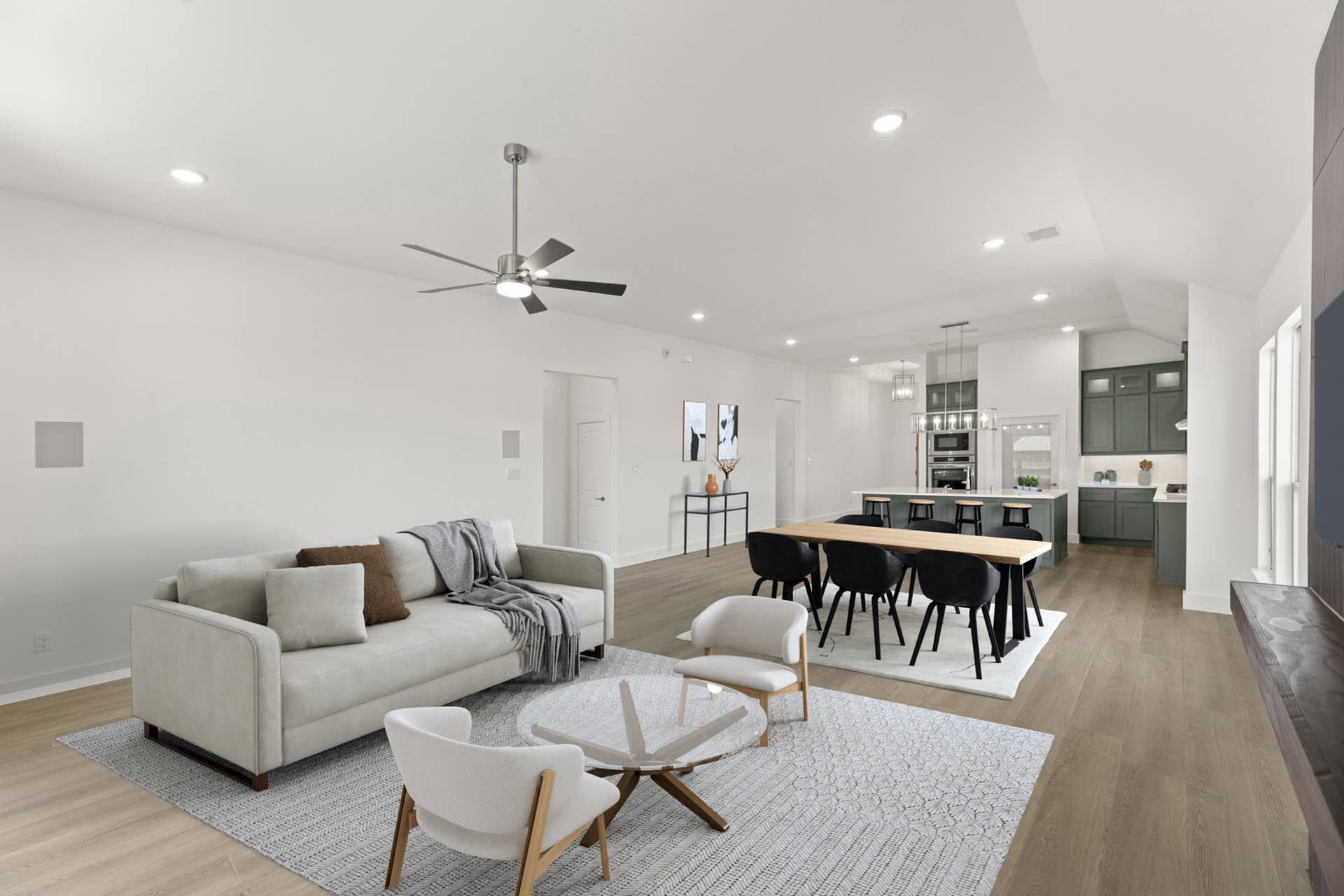 Modern open-concept living room with sleek kitchen and stylish furnishings.