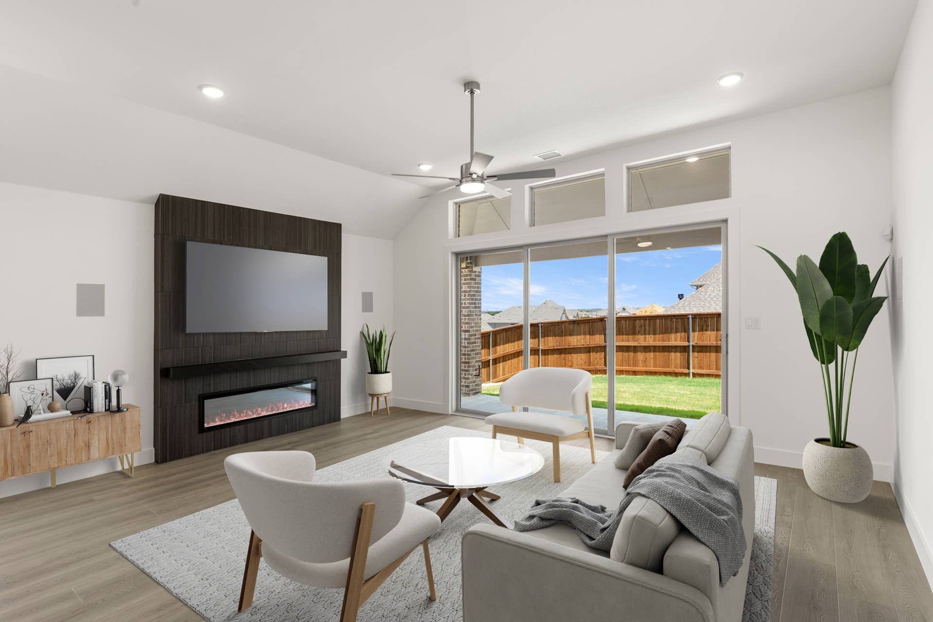 Modern living room with fireplace, large windows, and elegant furnishings.
