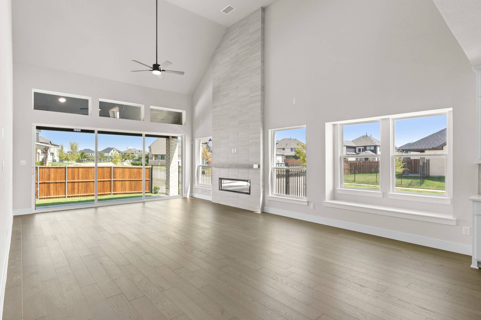 Spacious dining room with high ceilings, large windows, and modern fireplace.