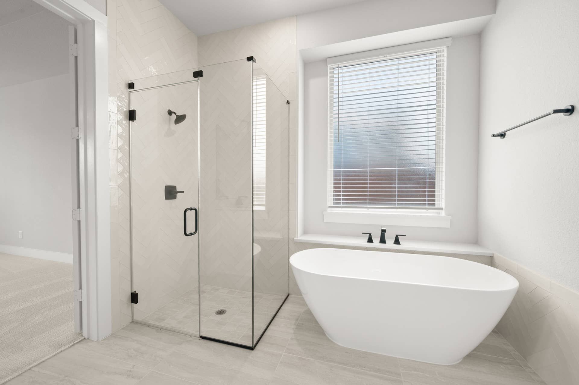 Modern bathroom with freestanding tub and glass-enclosed shower.