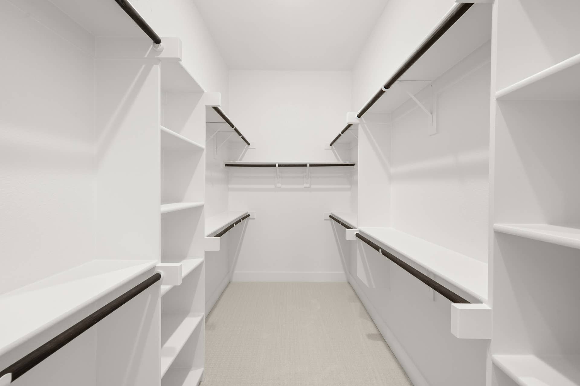 Spacious walk-in closet with ample shelving and hanging space.