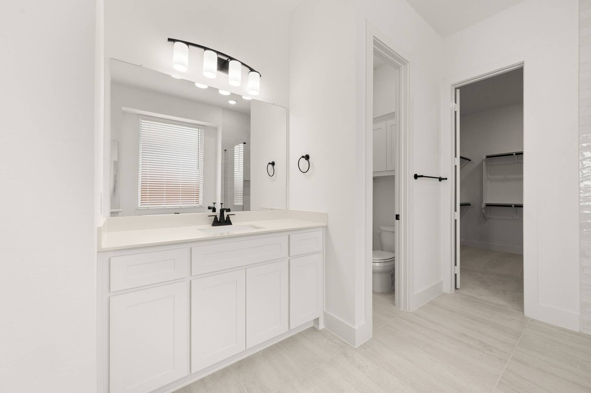 Spacious primary suite bathroom with modern fixtures and walk-in closet access.