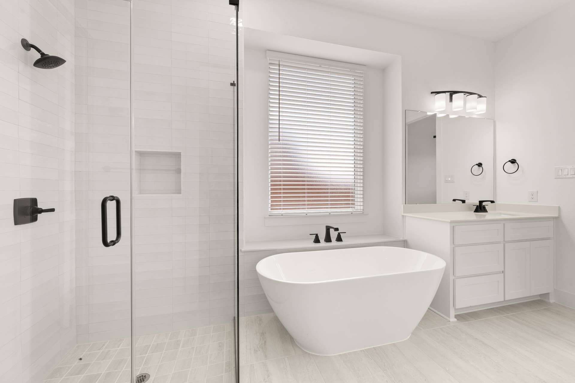 Contemporary bathroom with freestanding tub, glass shower, and modern fixtures.