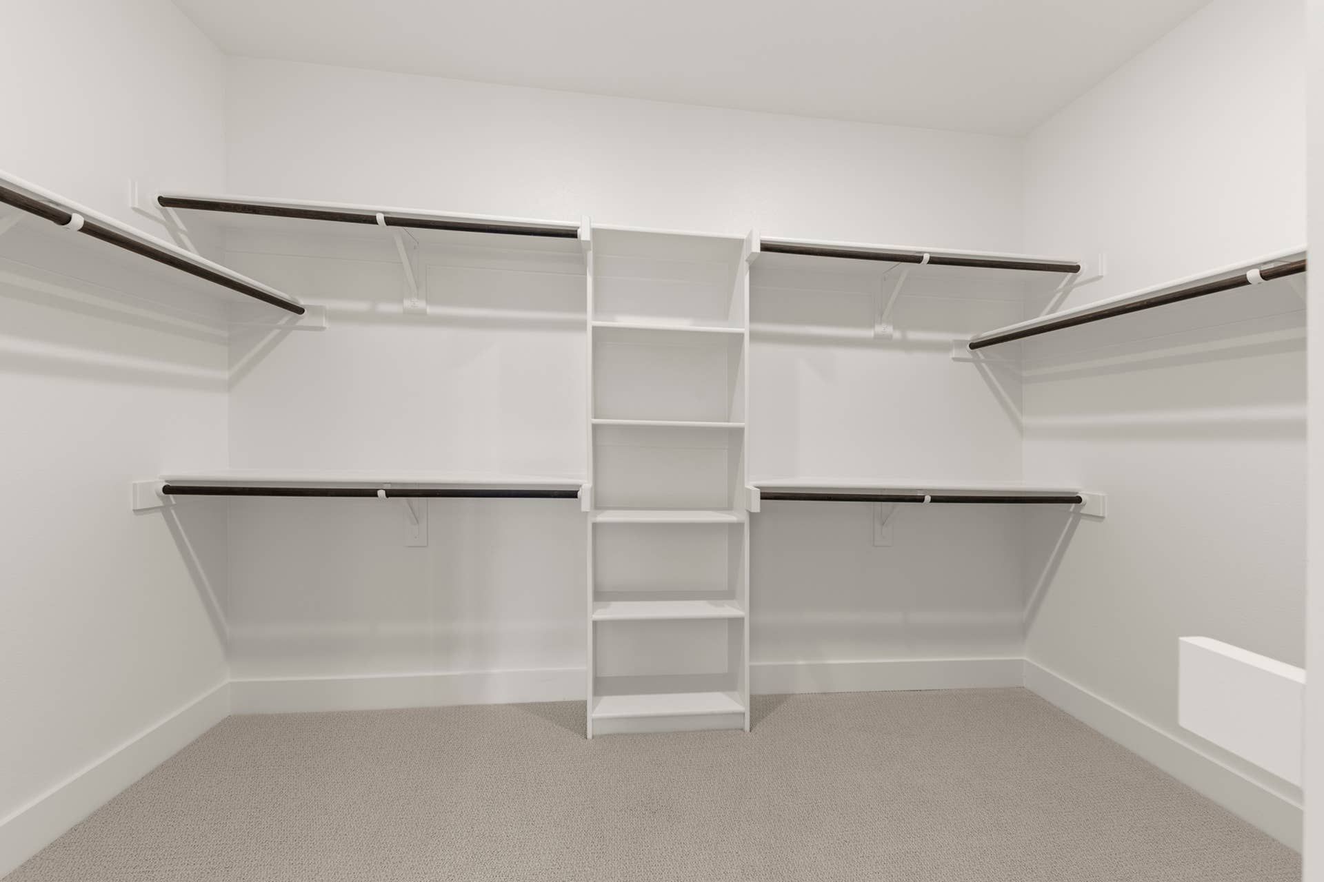 Spacious walk-in closet with shelving and hanging rods.