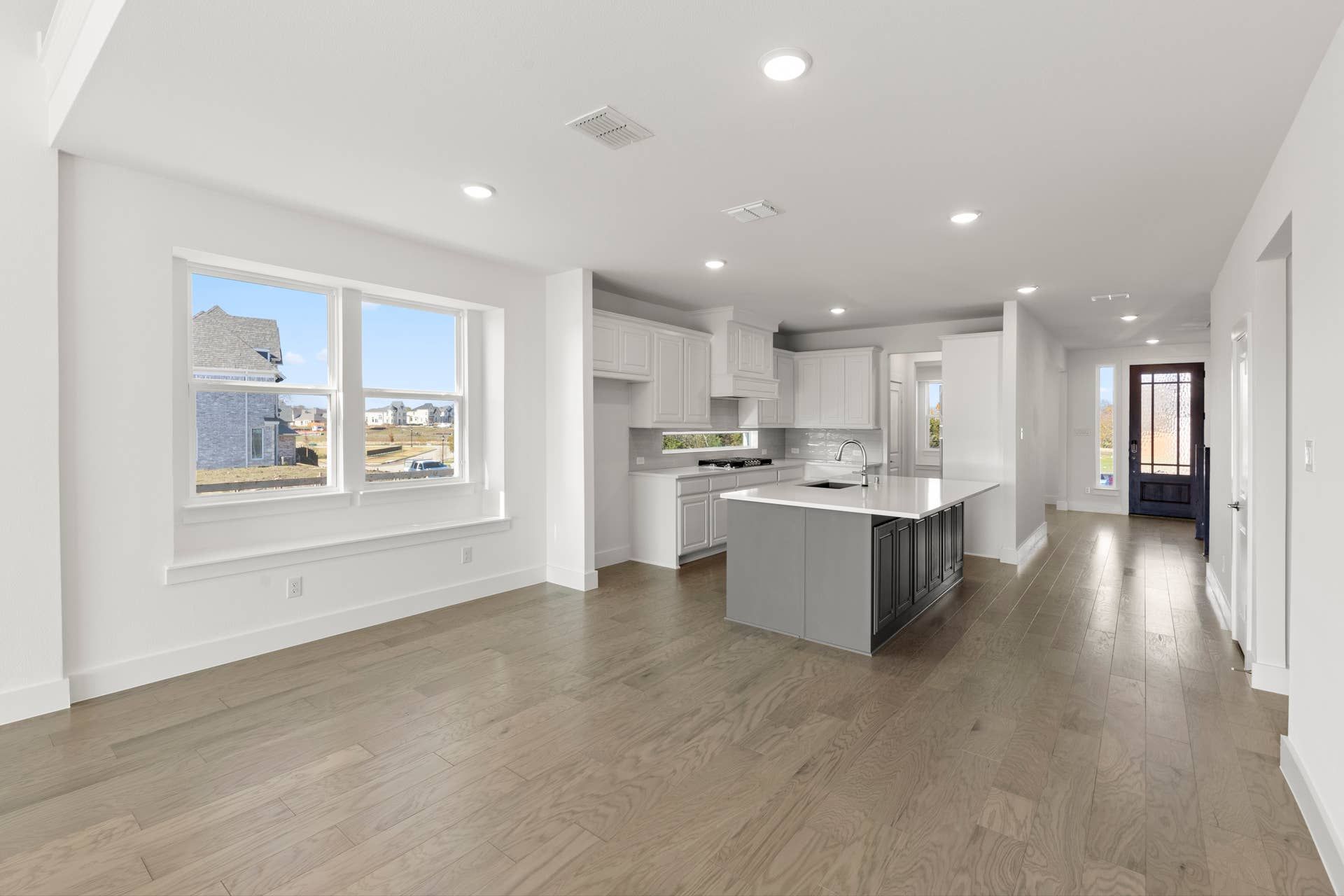 Spacious open-concept kitchen and dining area with hardwood floors and modern finishes.