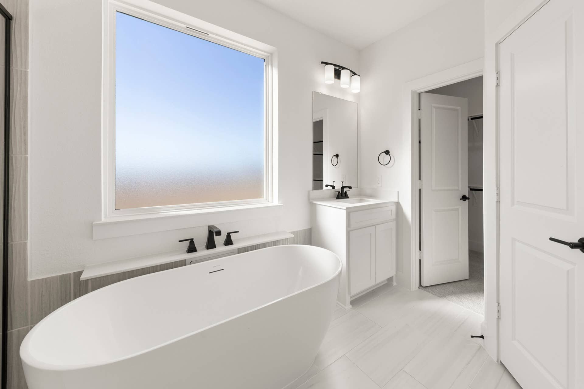 Modern bathroom interior with freestanding tub and sleek fixtures.