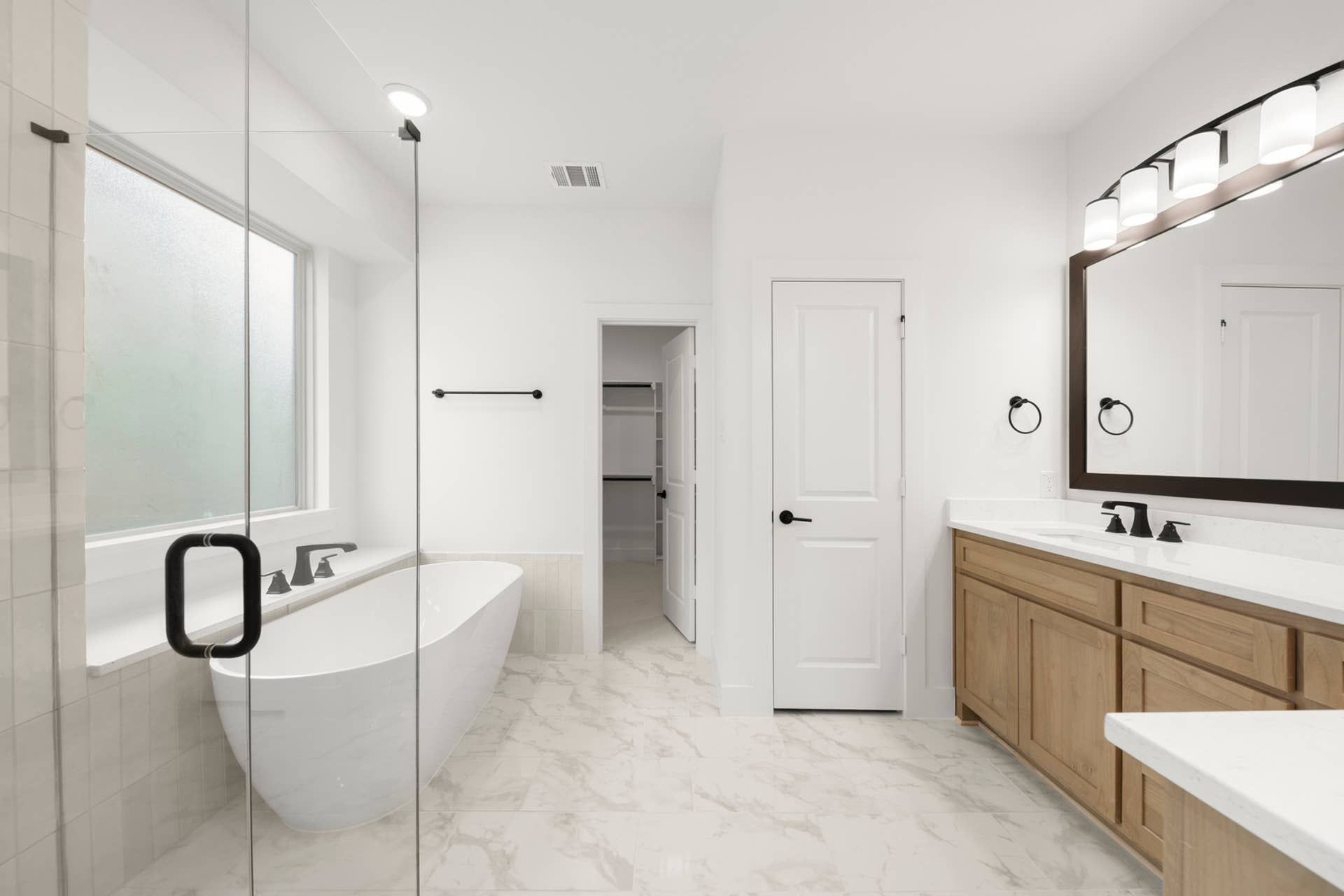Modern bathroom with freestanding tub and double vanity.