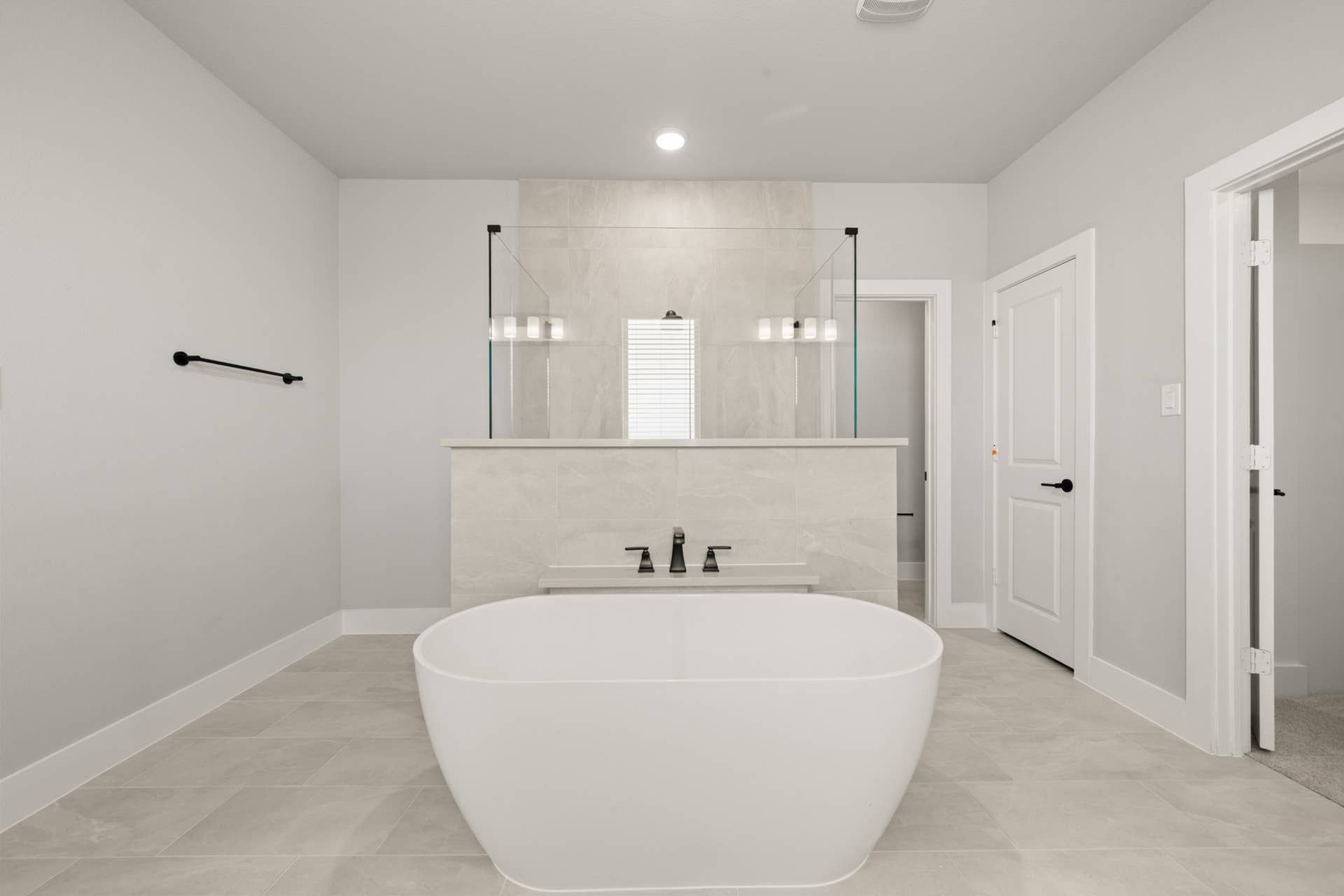 Spacious modern bathroom with freestanding tub and dual vanities.