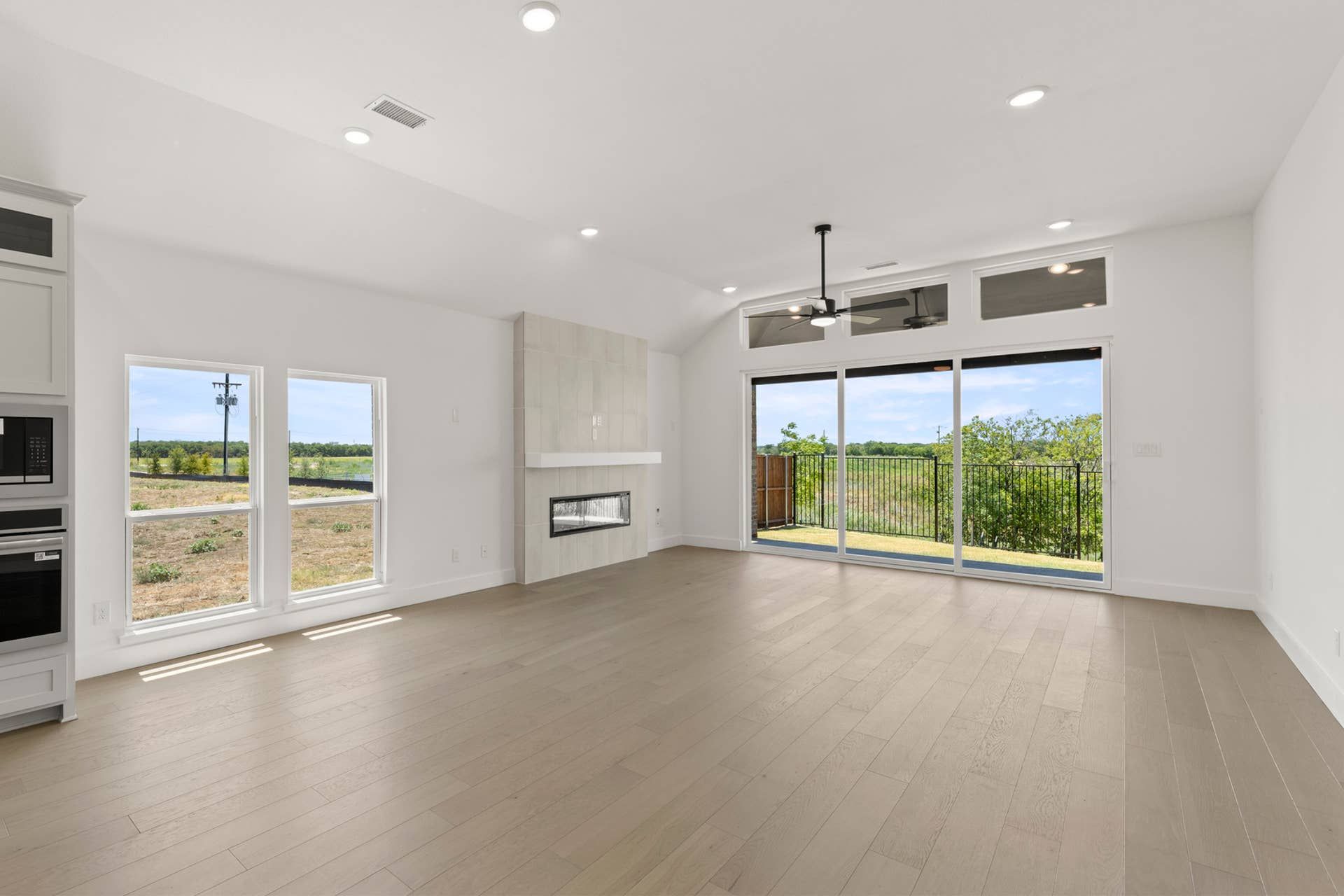 Spacious dining area with fireplace and large windows overlooking scenic outdoor view.