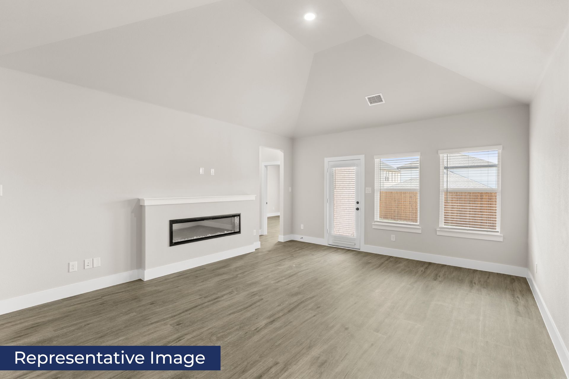 Spacious modern living room with fireplace and large windows.