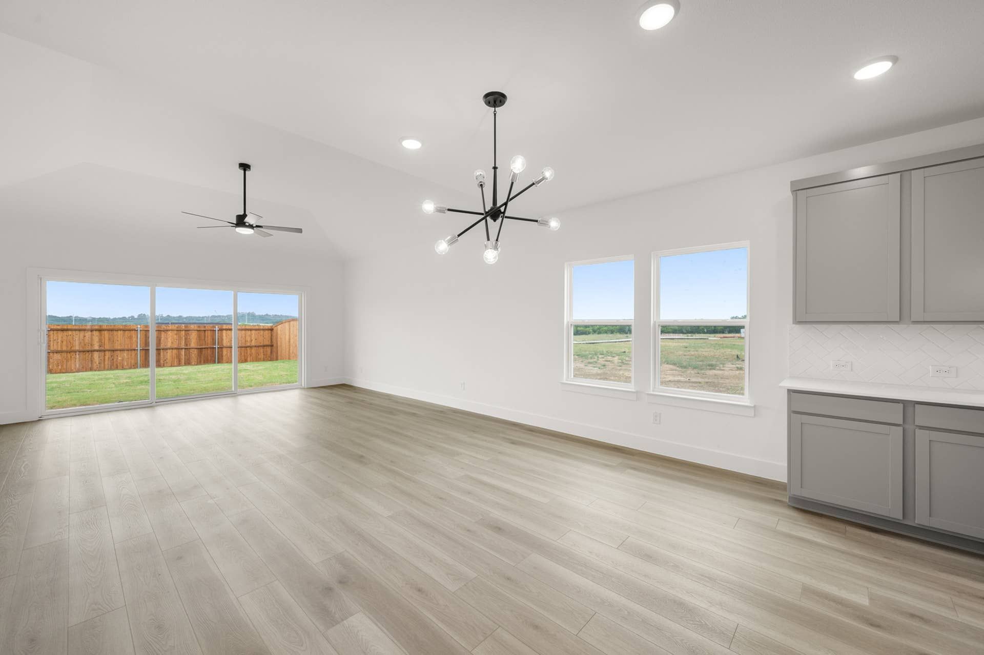 Spacious dining area with modern lighting, large windows, and scenic outdoor views.