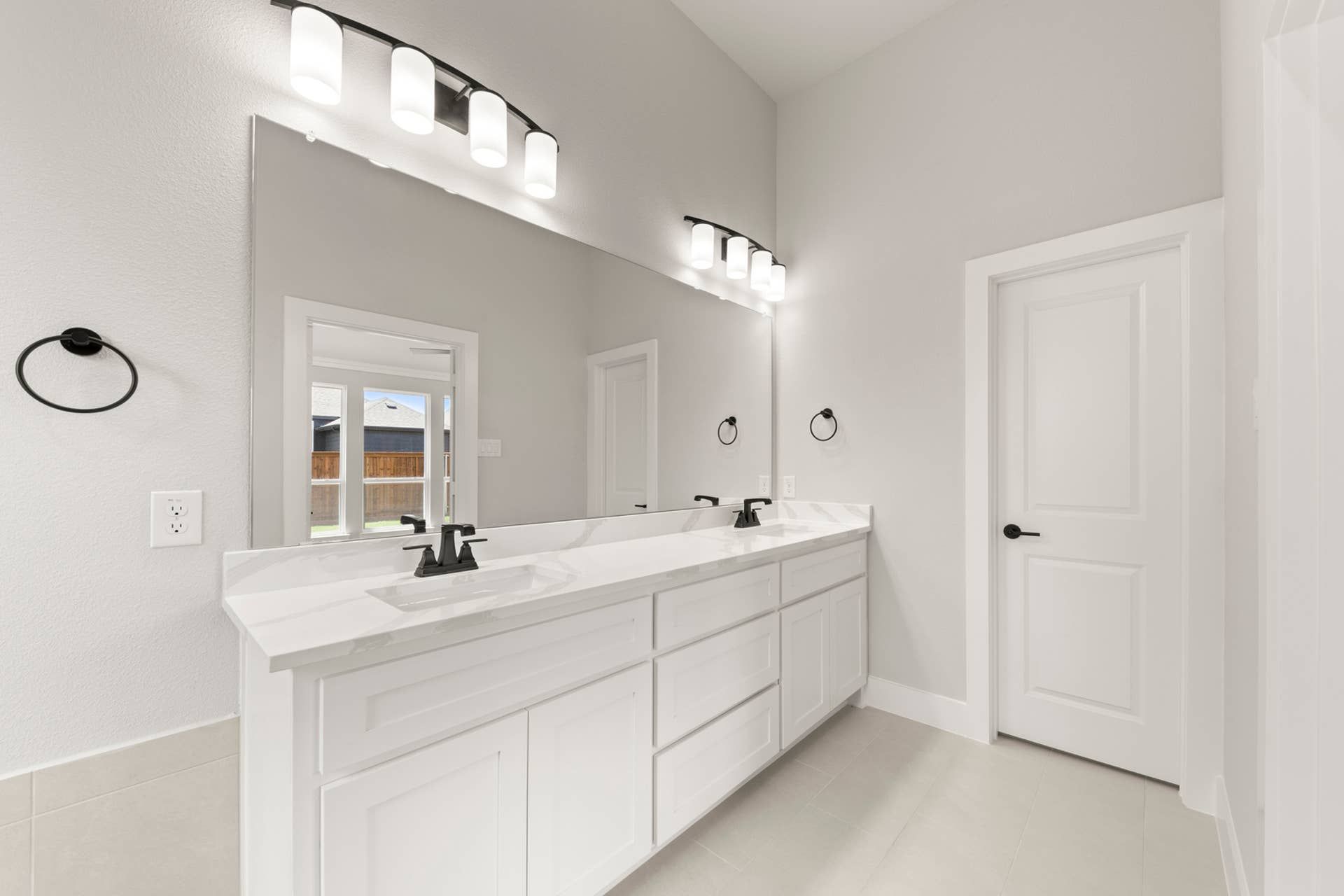 Modern bathroom with double sink vanity and large mirror.