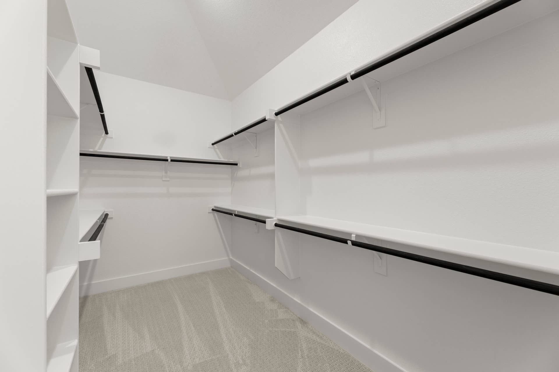 Spacious walk-in closet with multiple shelves and hanging rods.