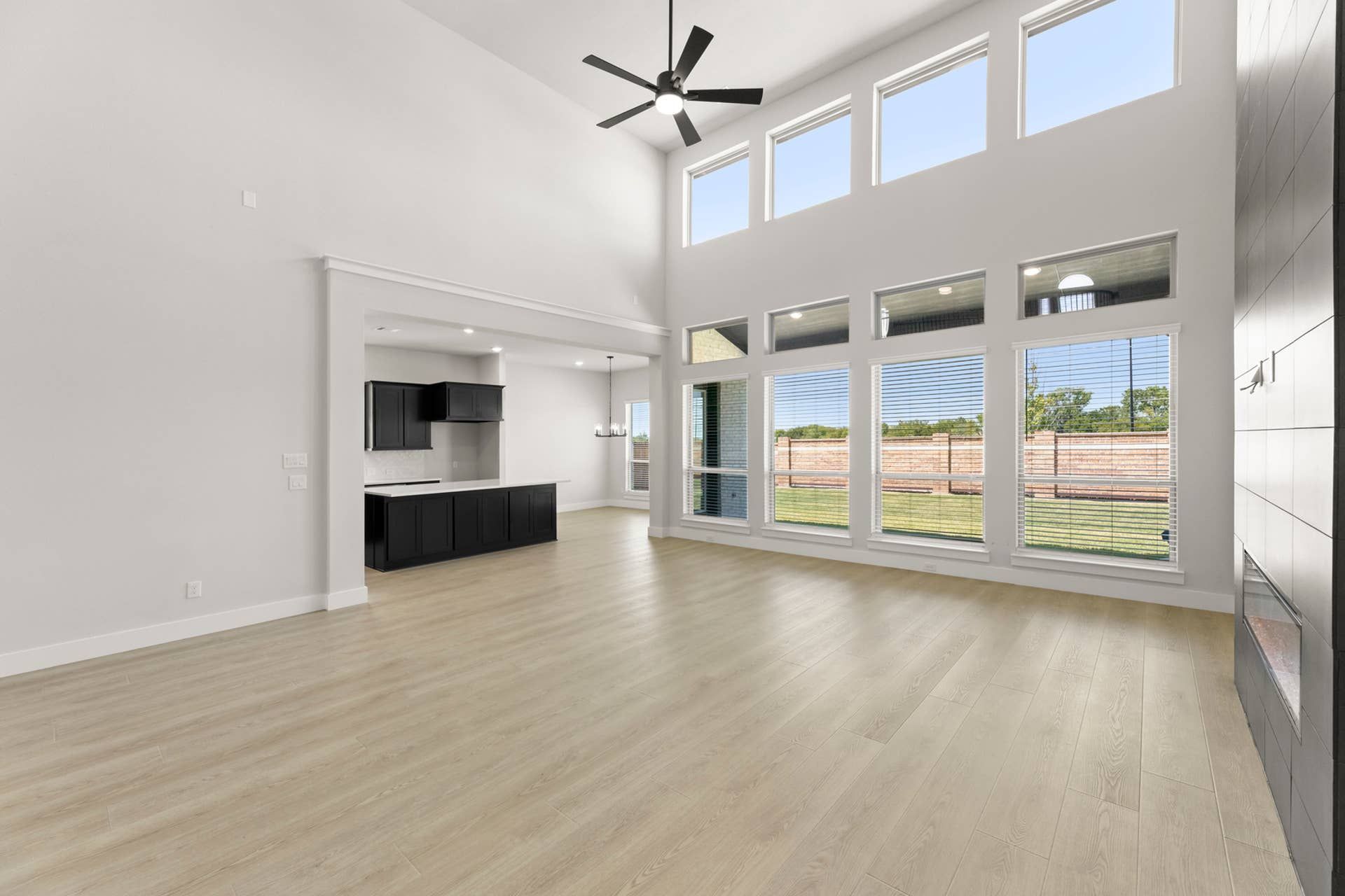 Spacious modern living room with high ceilings and large windows for natural light.
