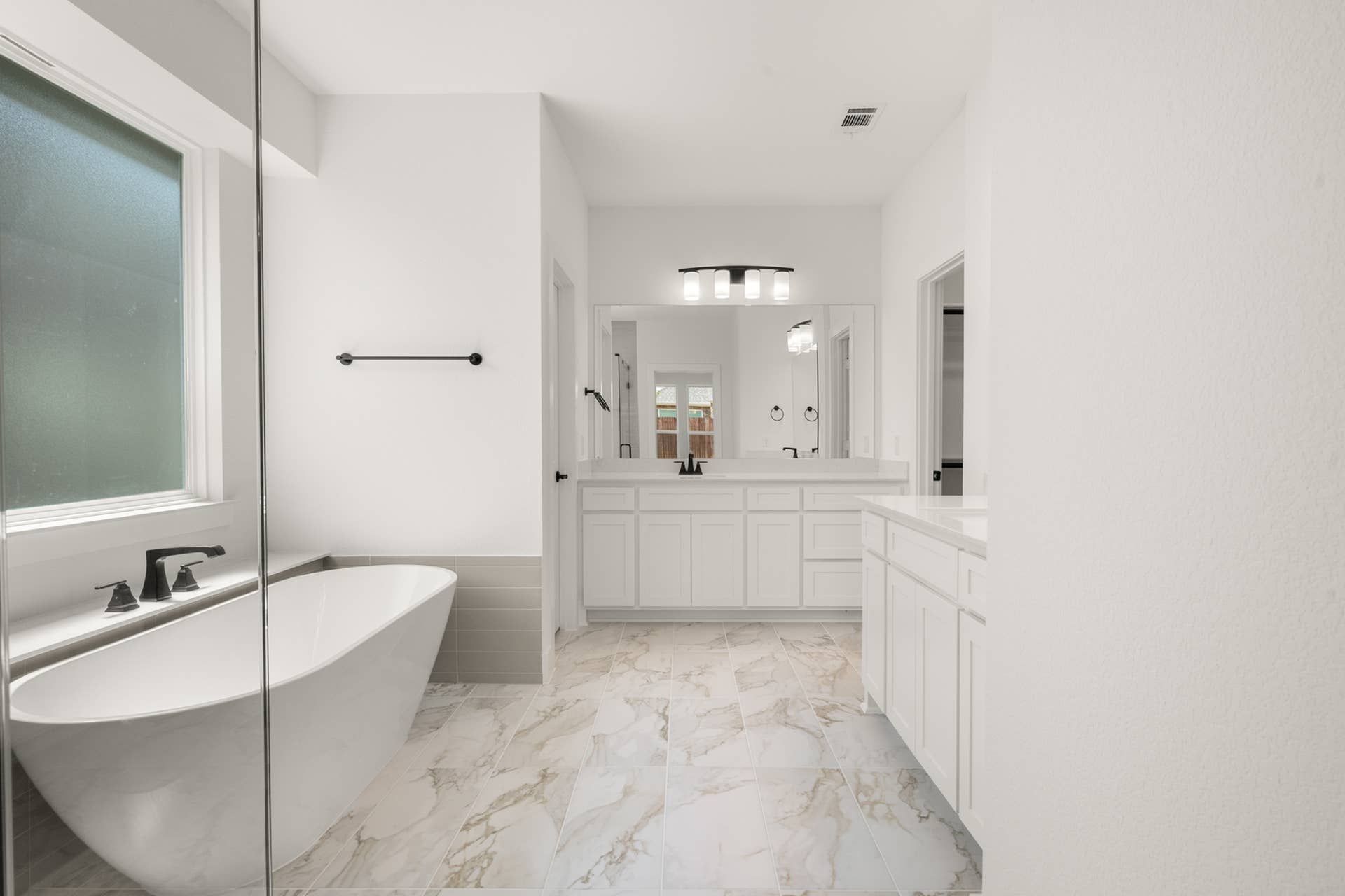 Elegant bathroom with freestanding tub and dual-sink vanity.