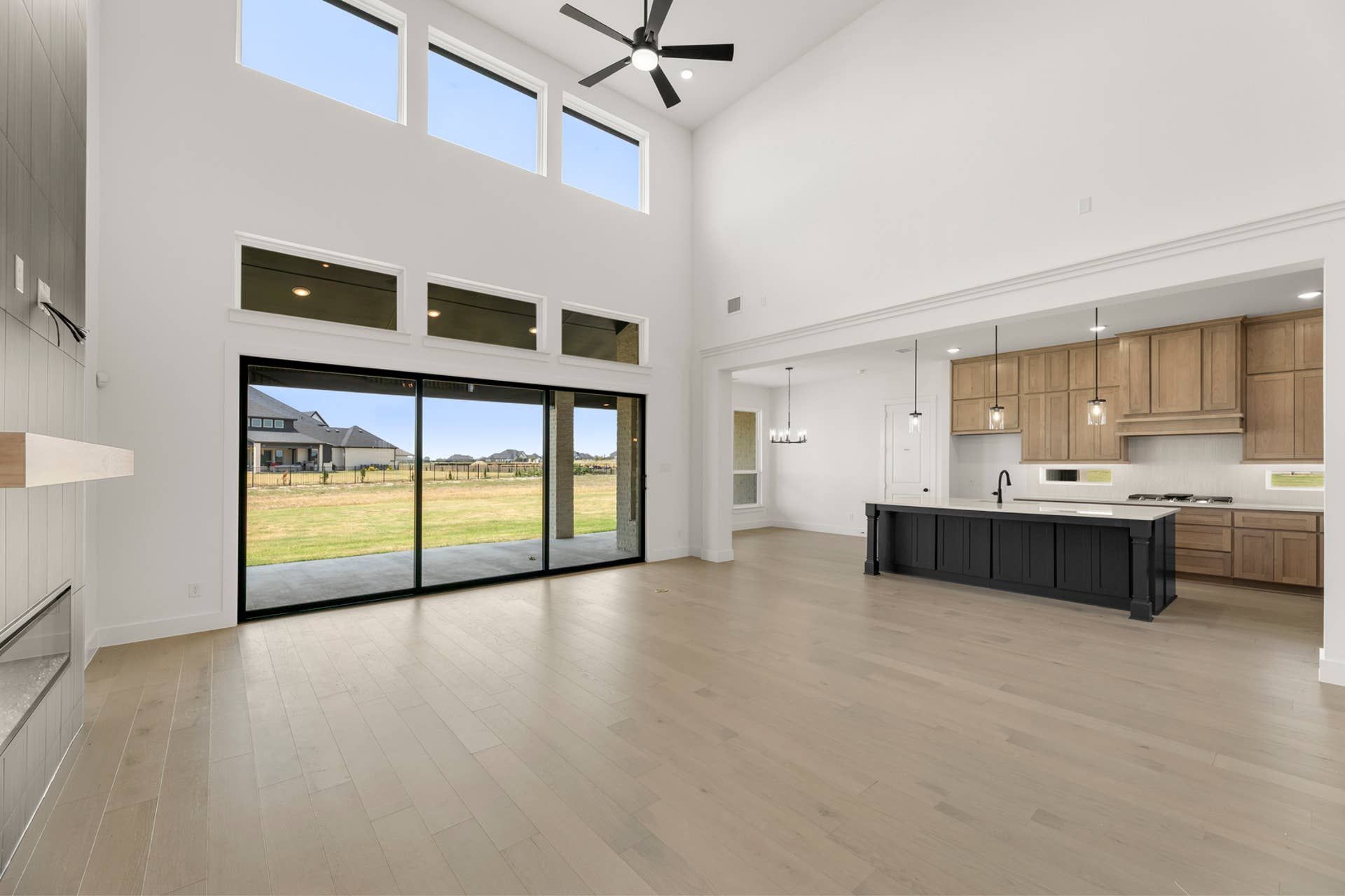 Spacious open-plan living area with high ceilings and modern kitchen.