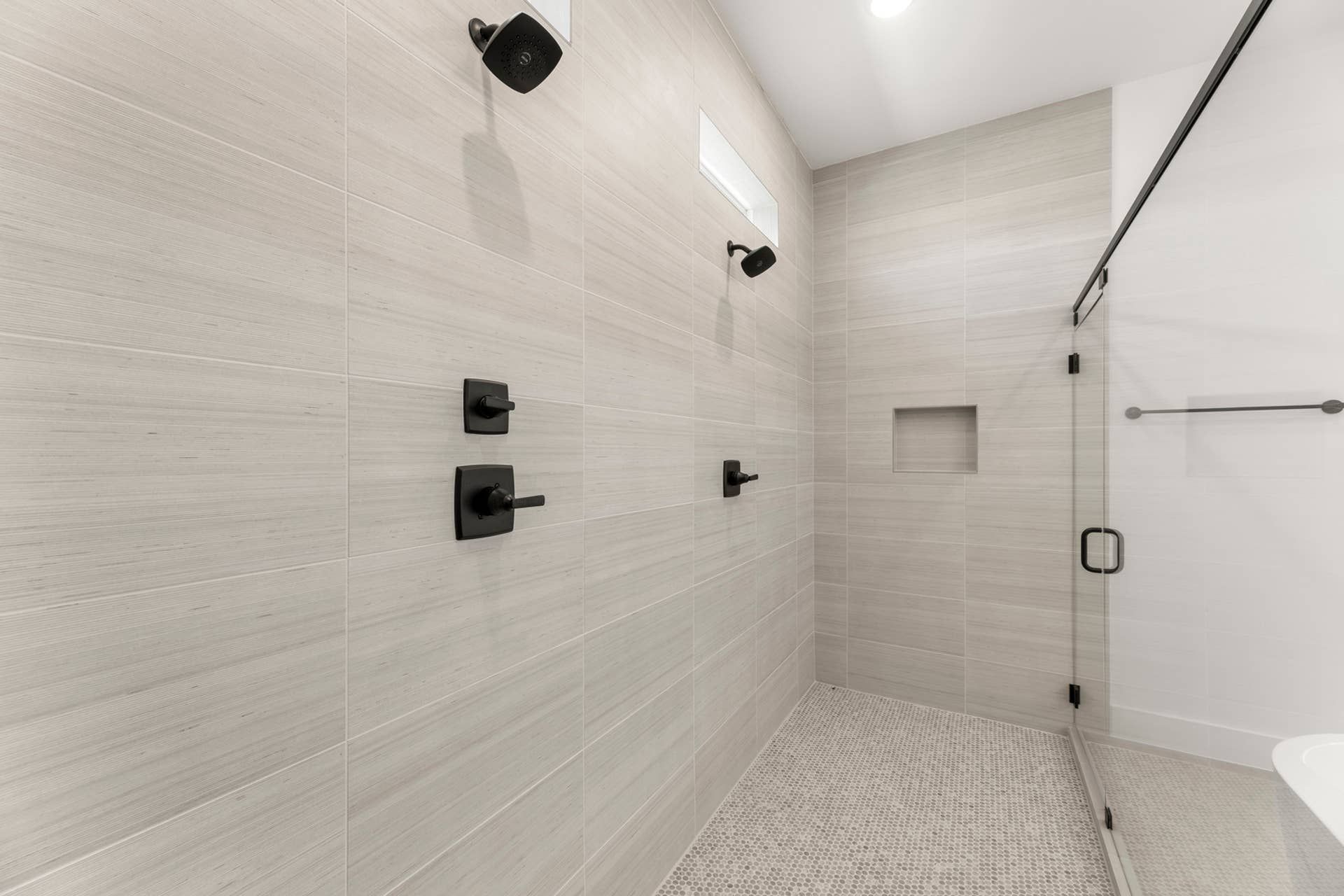Modern bathroom shower with glass door and sleek fixtures.