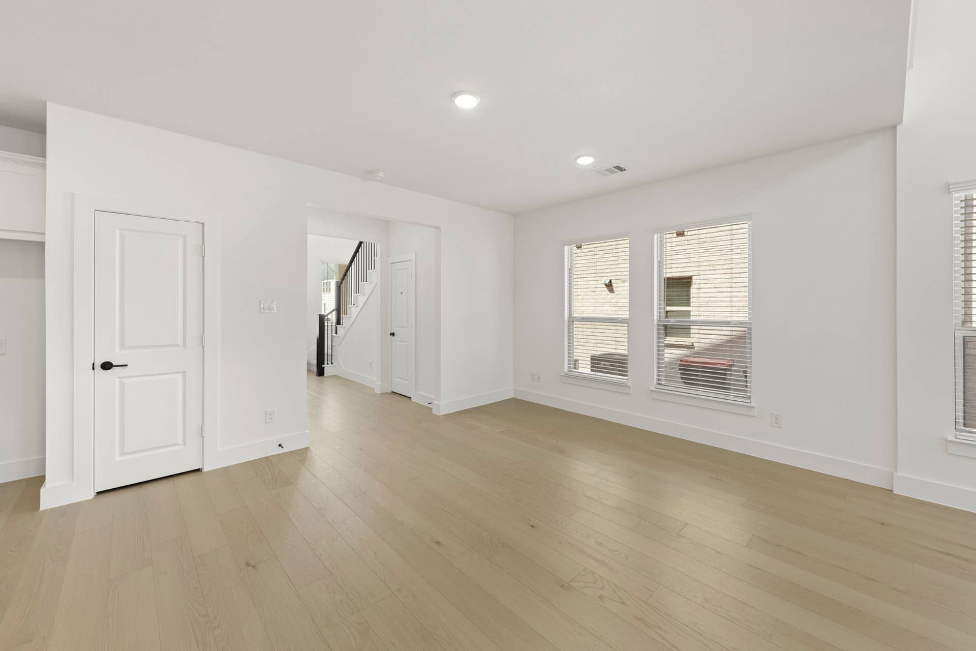Bright dining area with hardwood floors and white walls.