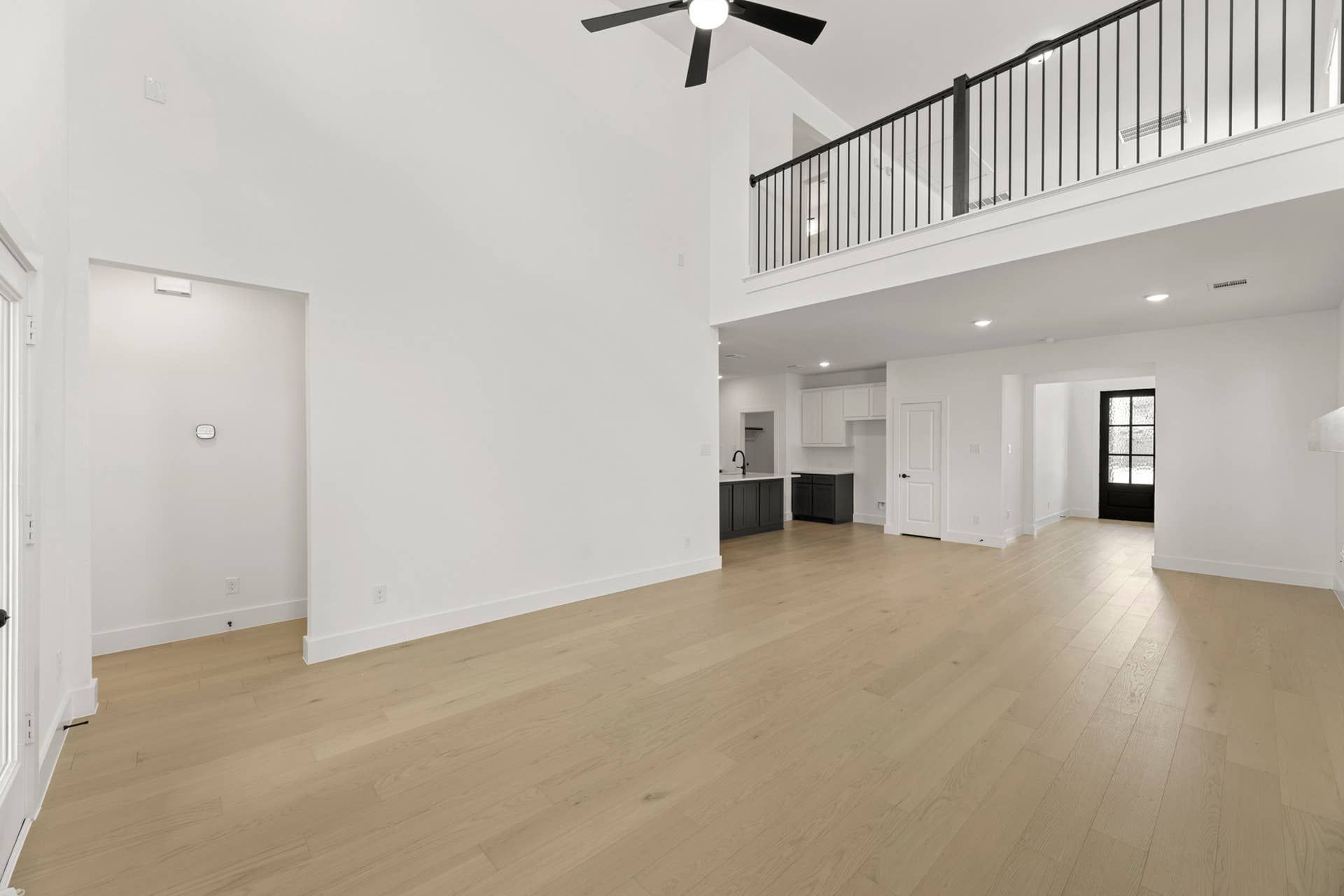 Spacious modern living area with high ceilings and open loft design.