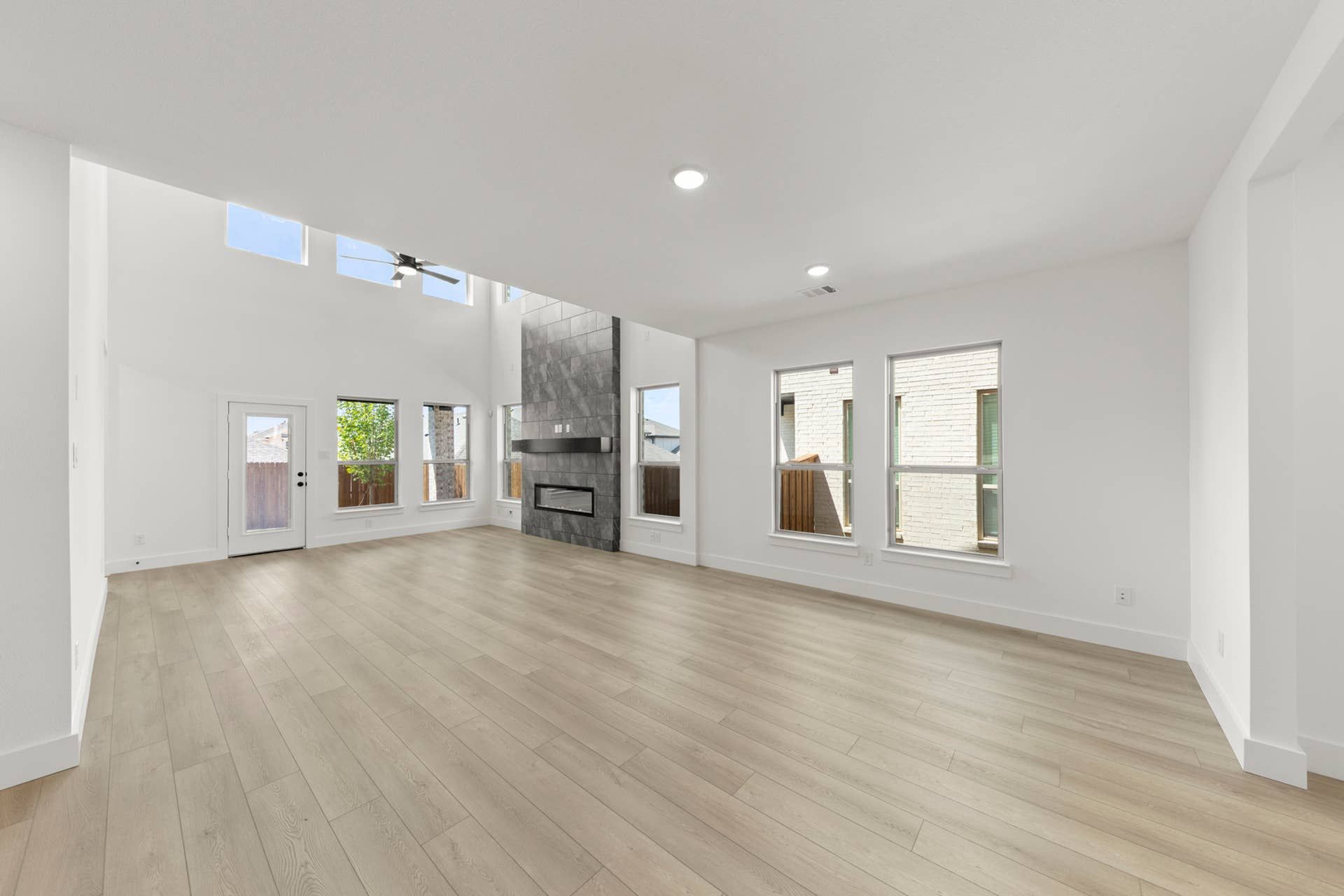Spacious dining area with large windows and modern fireplace.
